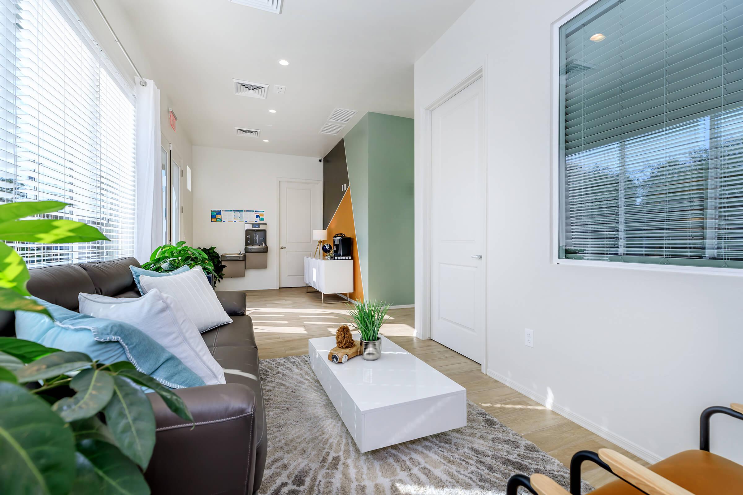 a living room filled with furniture and a large window