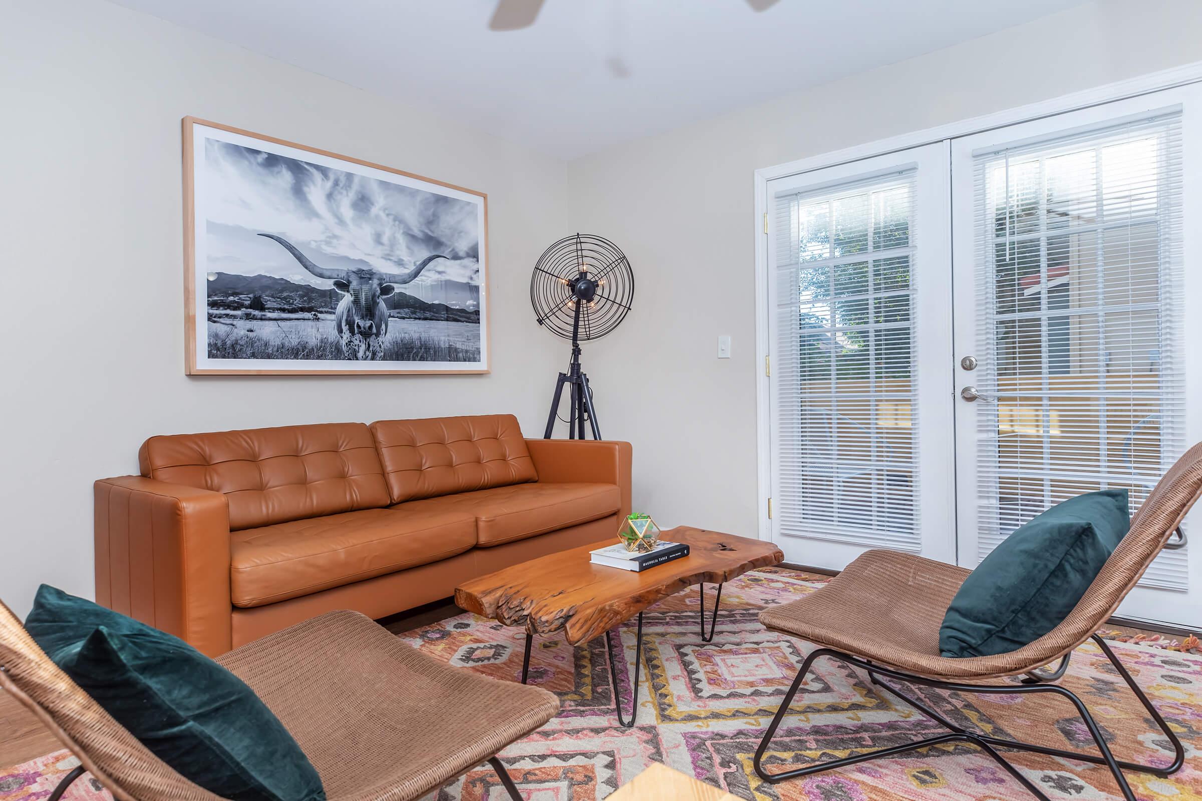 a living room filled with furniture and a large window