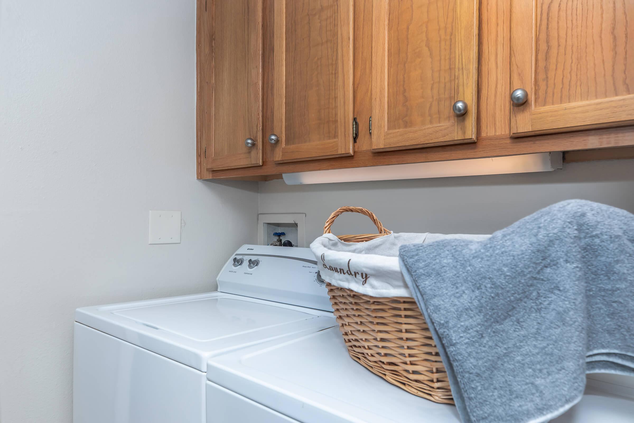 a kitchen with wooden cabinets and a microwave