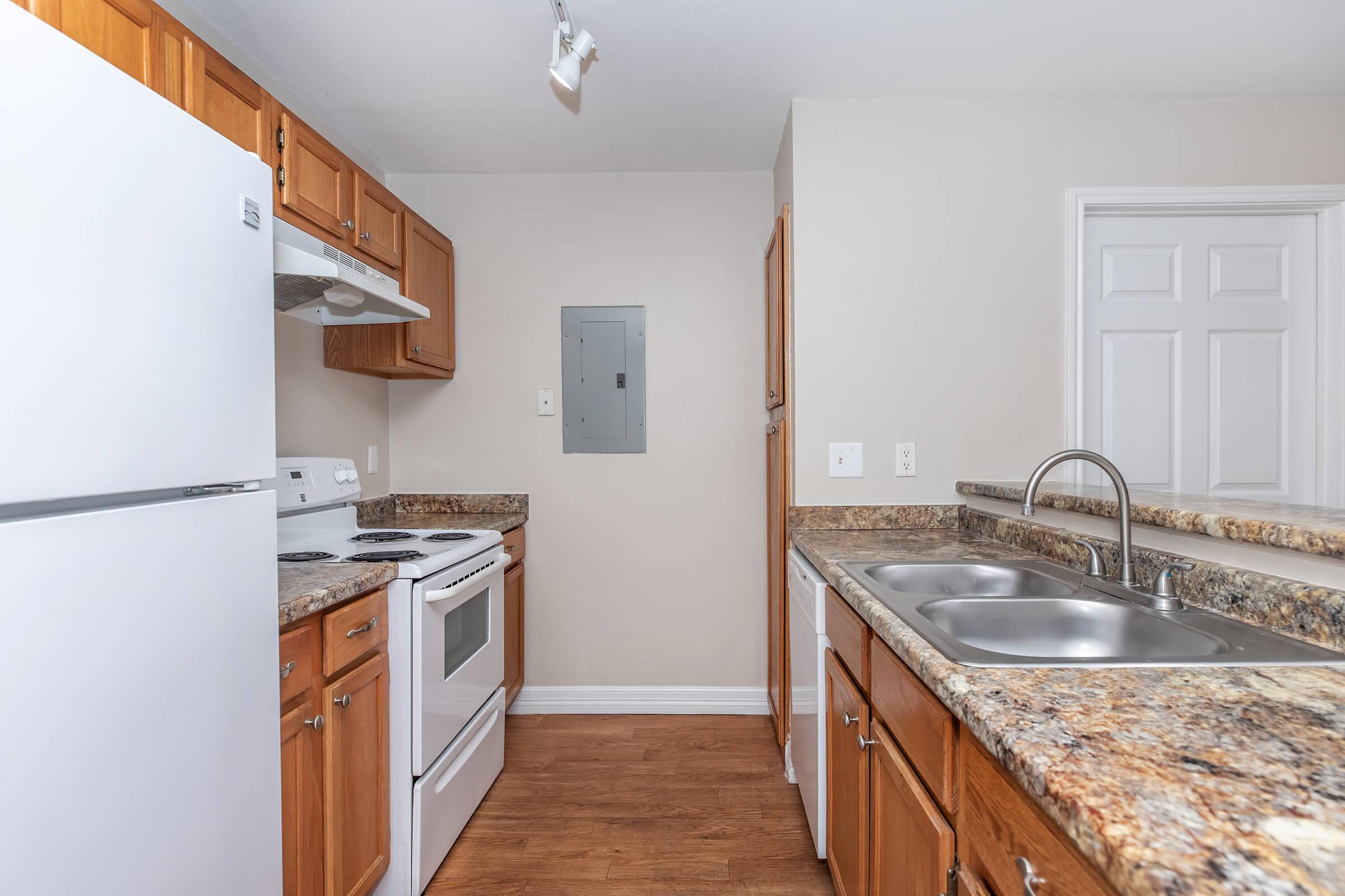 a kitchen with a stove sink and refrigerator