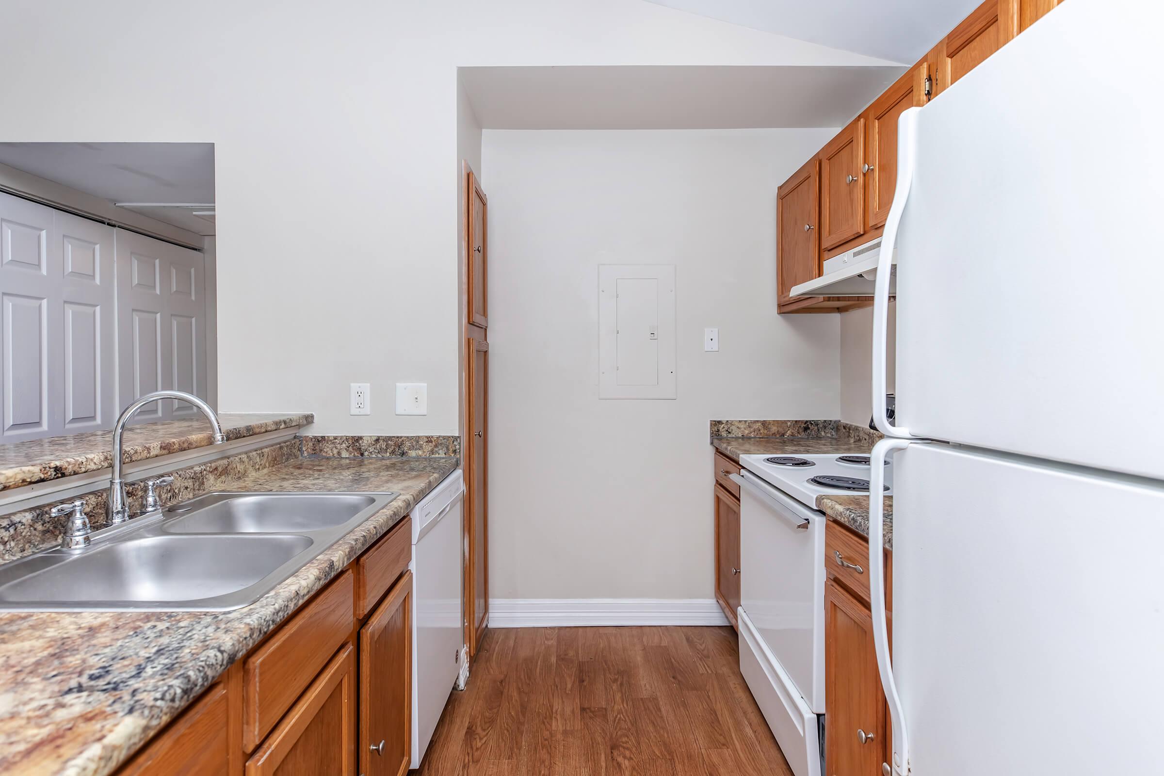 a kitchen with a sink and a refrigerator