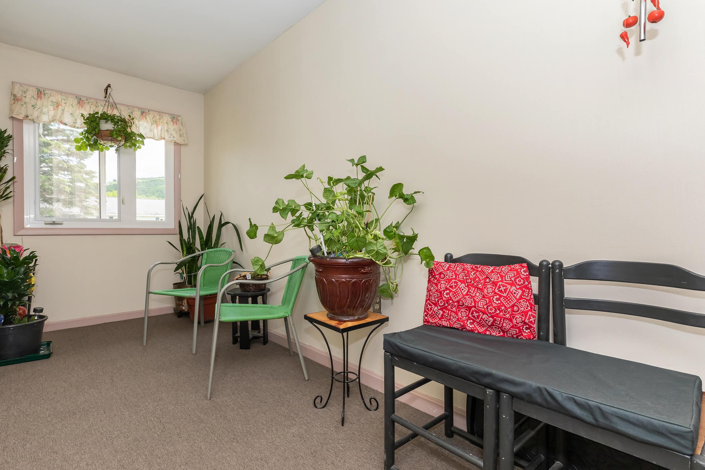 a living room filled with furniture and vase of flowers on a table