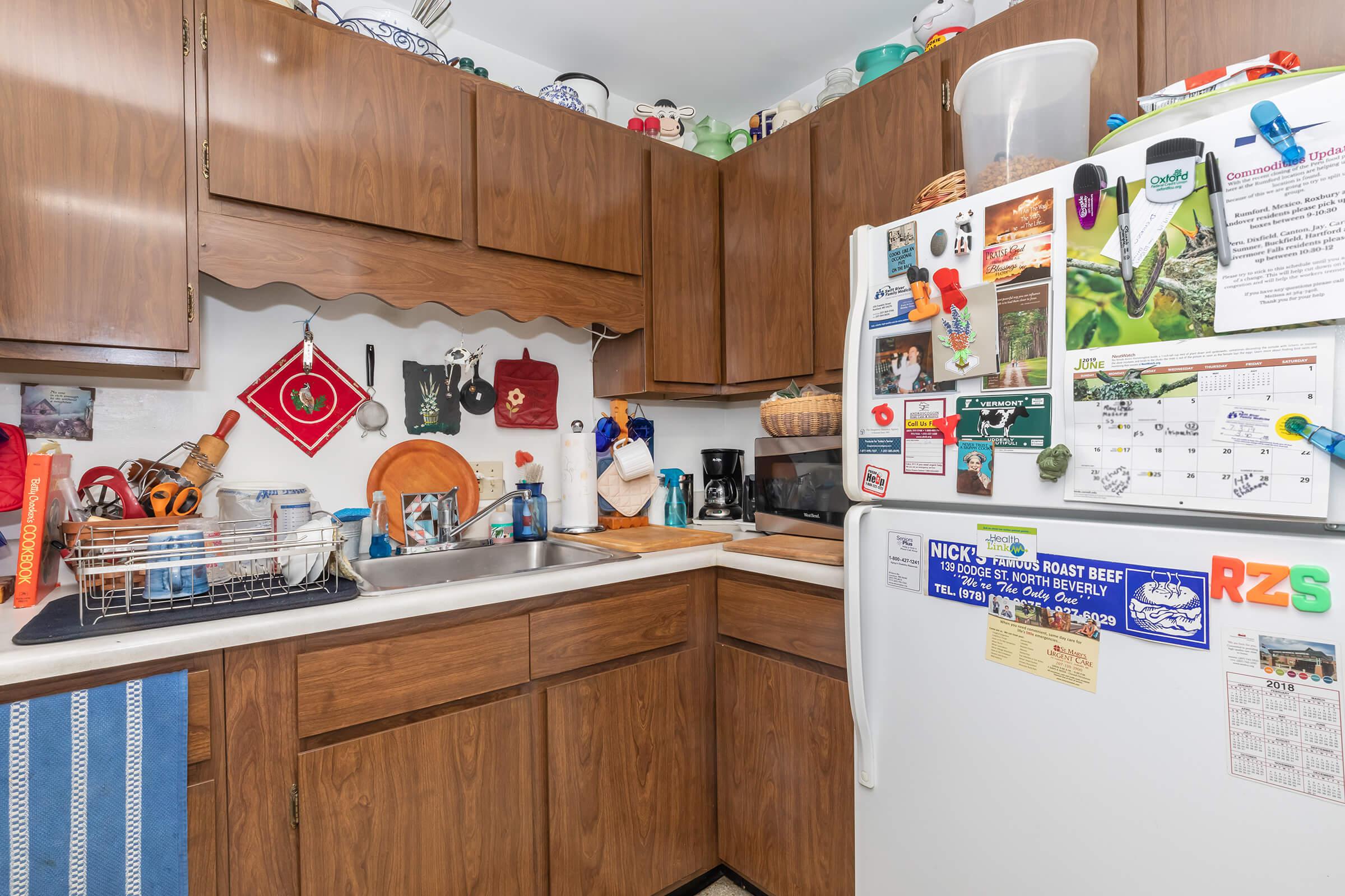 a white refrigerator freezer sitting inside of a kitchen