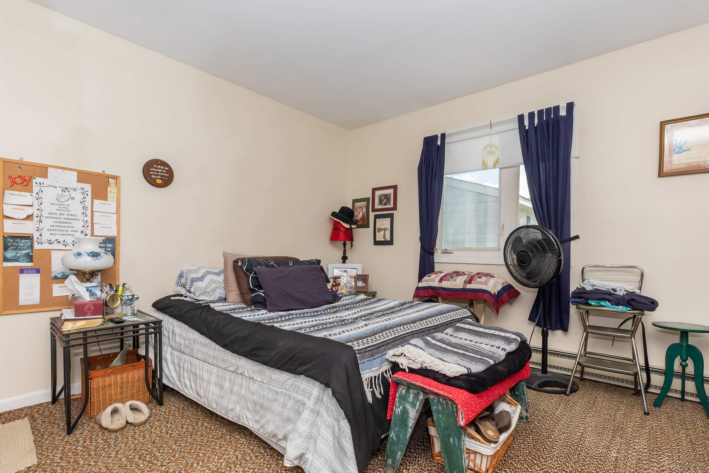 a living room filled with furniture and a bed