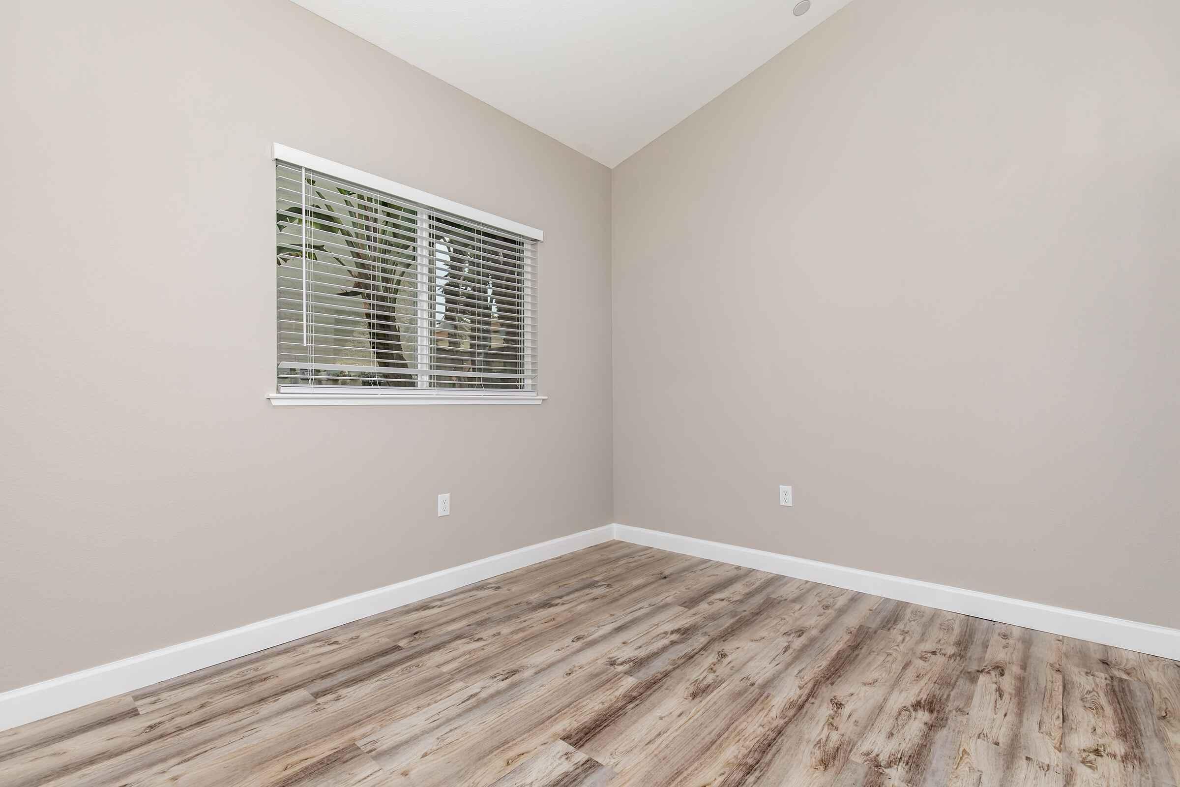 a bedroom with a wooden floor