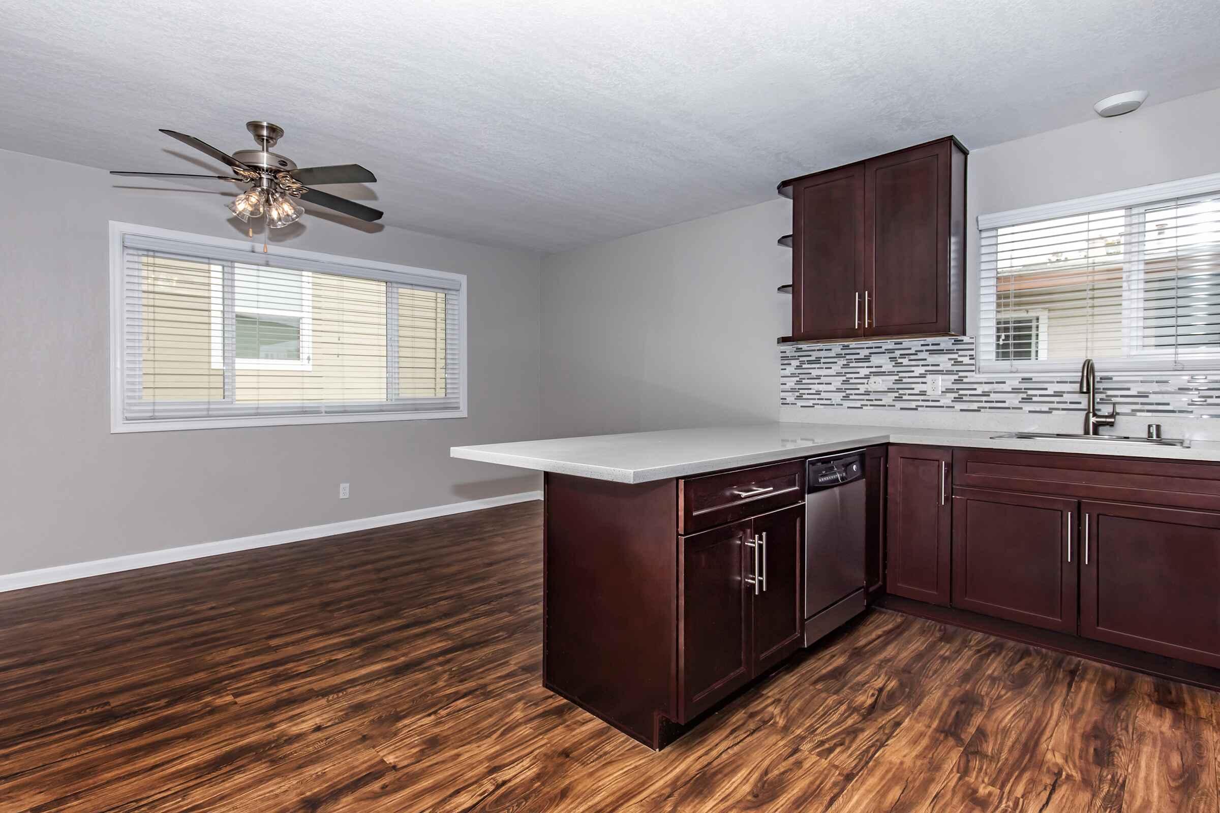 a modern kitchen with stainless steel appliances and wooden cabinets