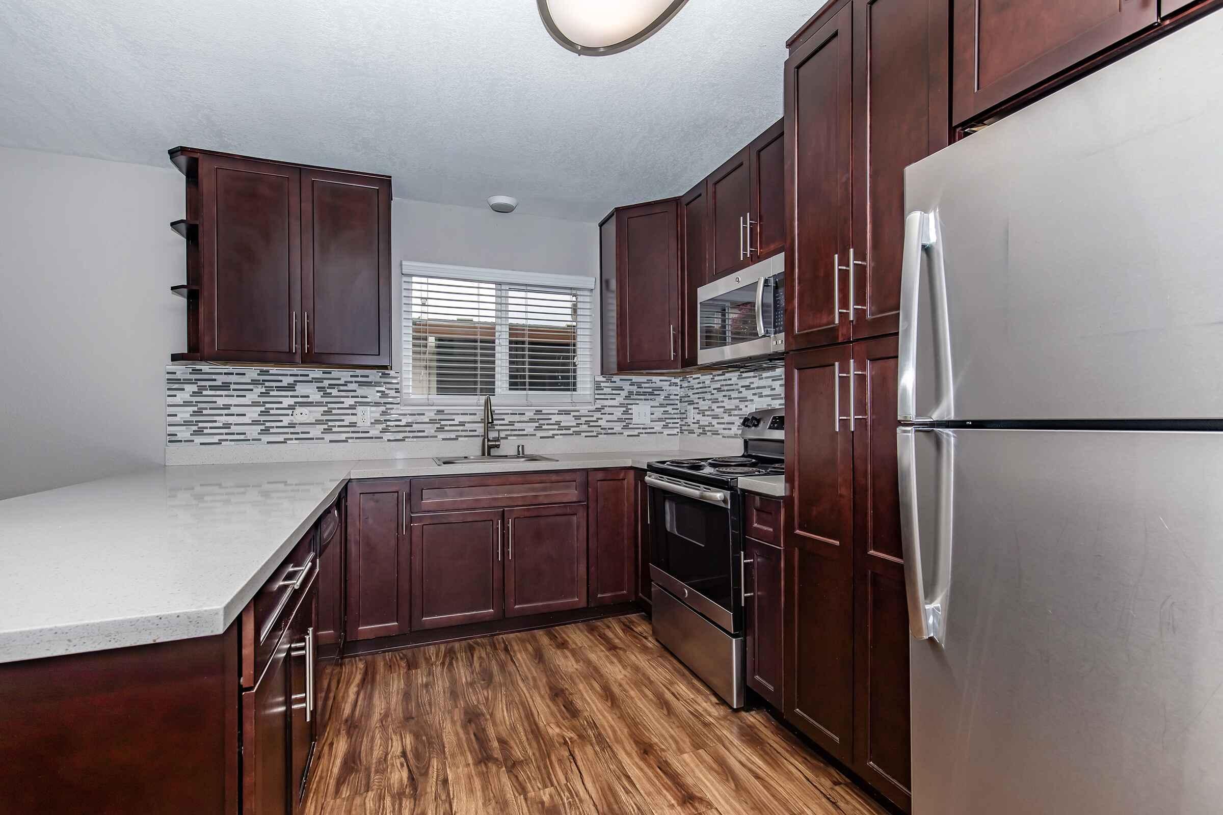 a kitchen with stainless steel appliances and wooden cabinets