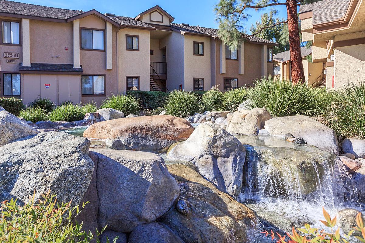 Water falling over rocks with community building