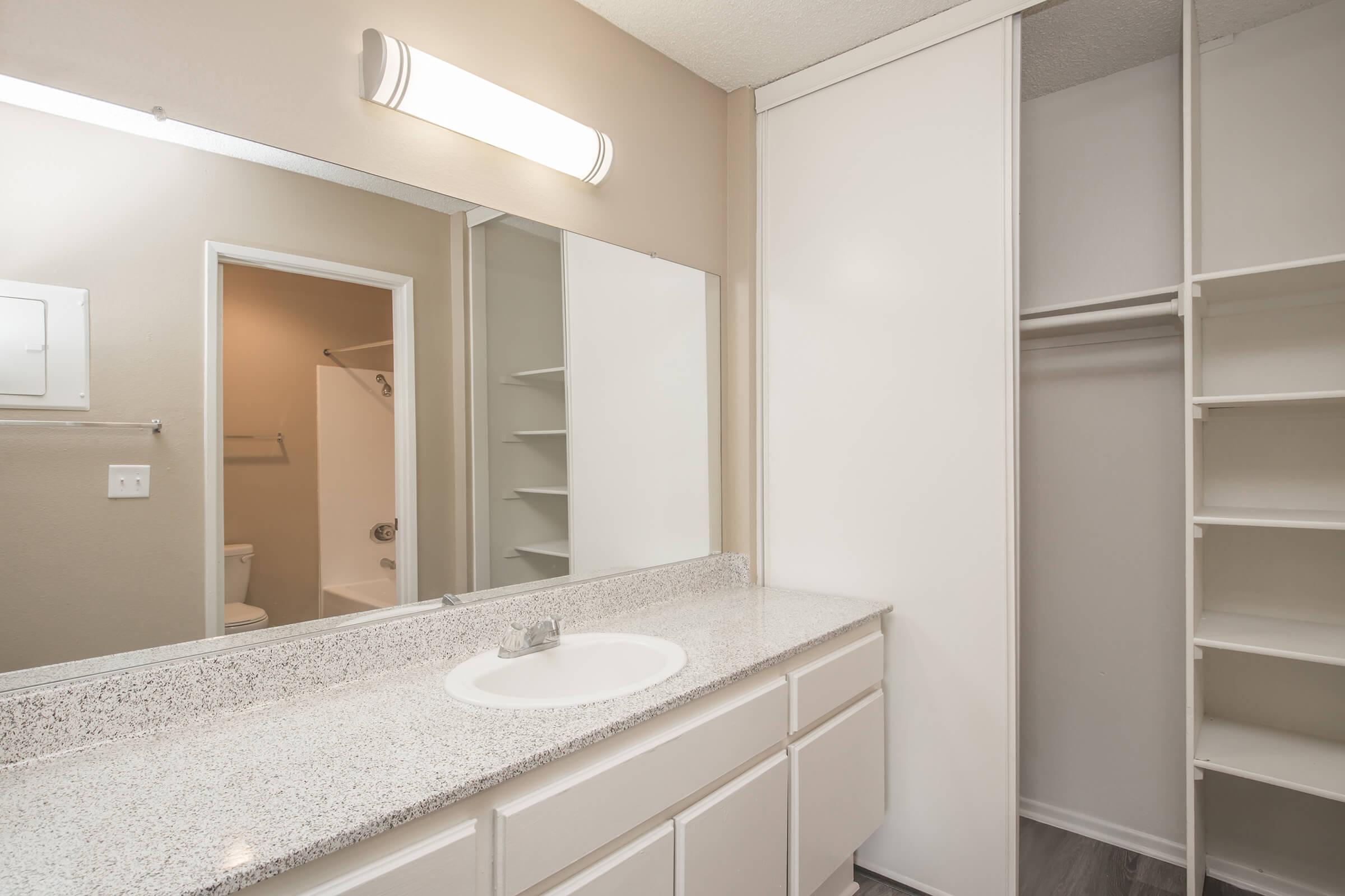 Bathroom sink with open closet door