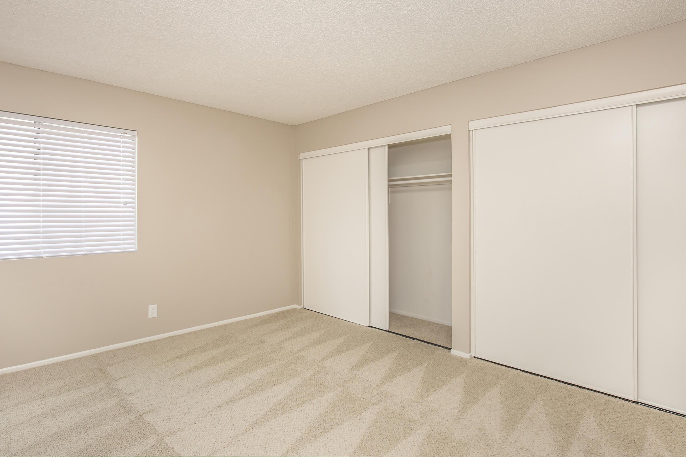 Unfurnished bedroom with open sliding closet doors