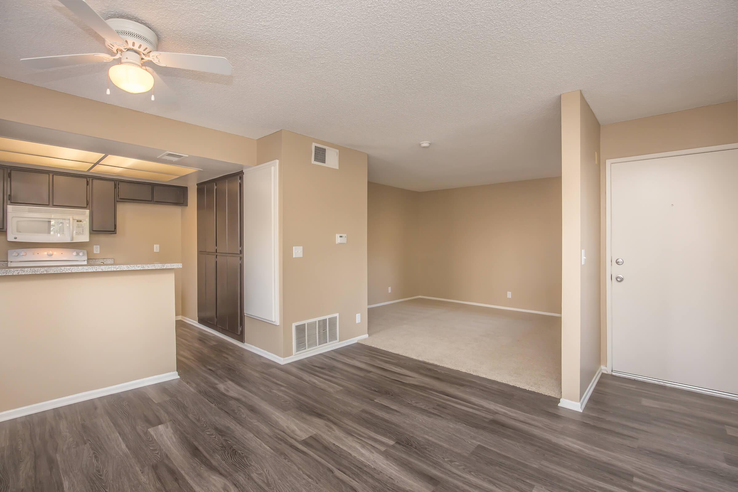 Carpeted living room and wooden floored dining room