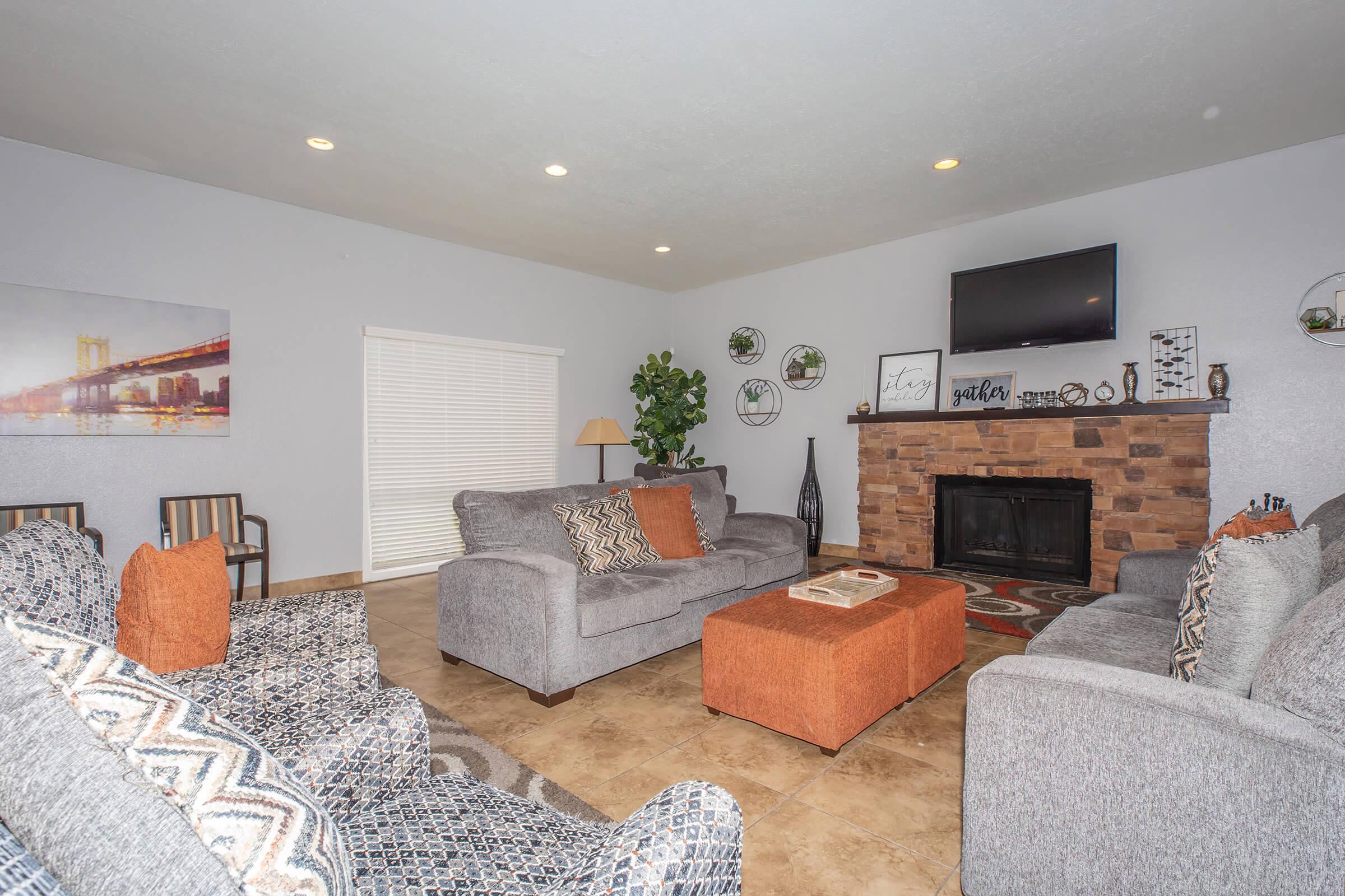 a living room filled with furniture and a fireplace