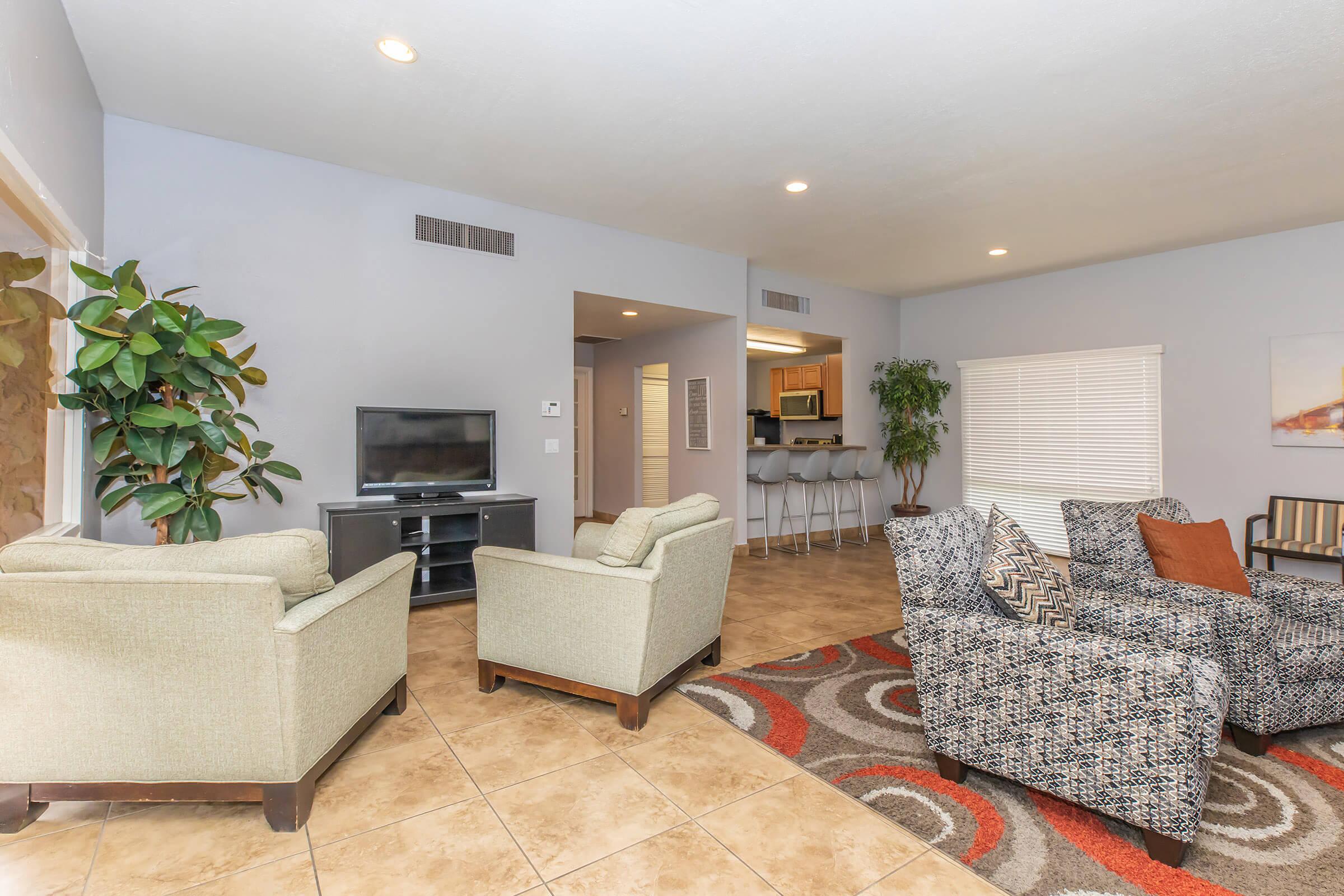 a living room filled with furniture and a flat screen tv