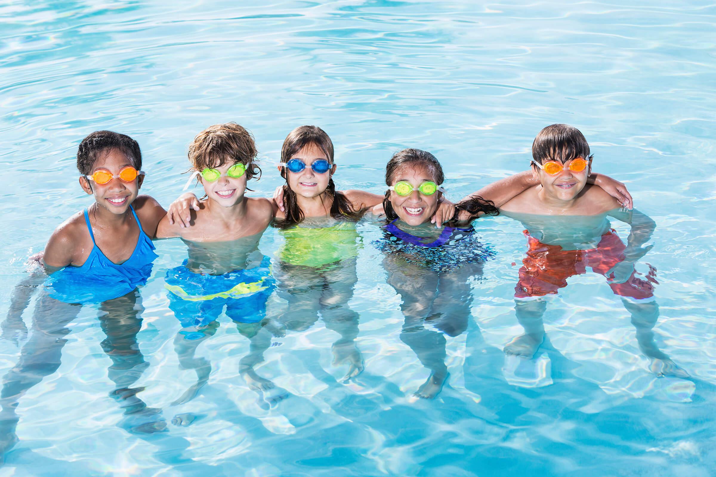 a group of people swimming in a pool of water