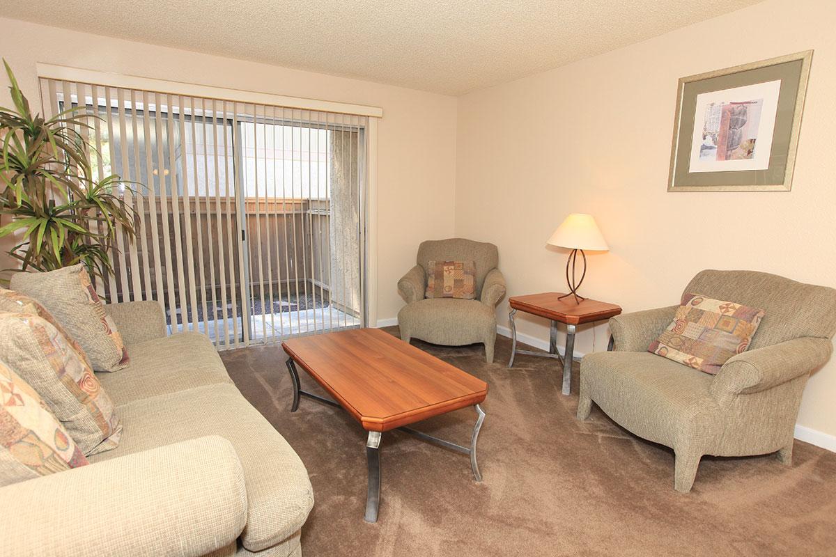 a living room filled with furniture and a lamp