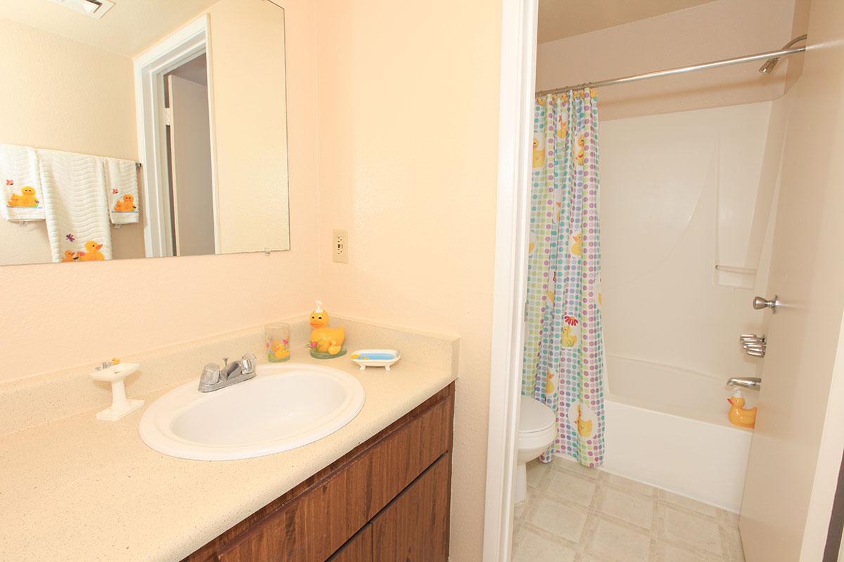 a large white tub sitting next to a sink