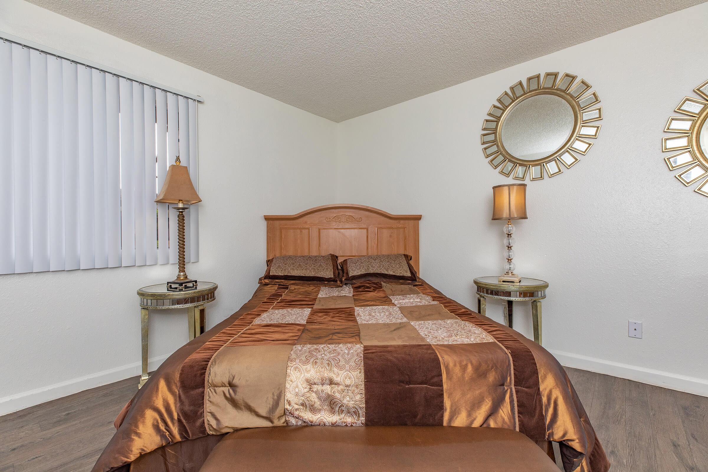 a bedroom with a clock at the top of a bed