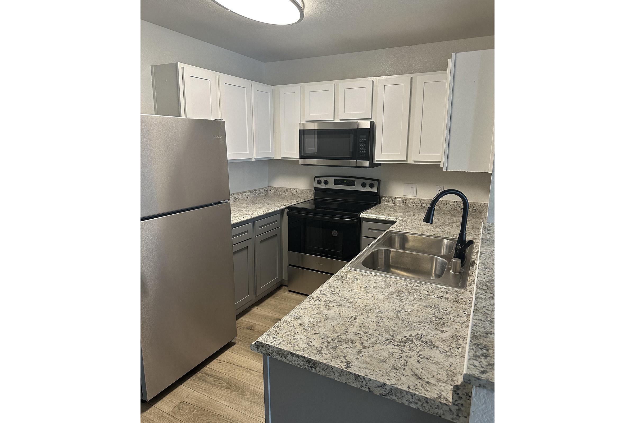 a kitchen with a sink and a refrigerator