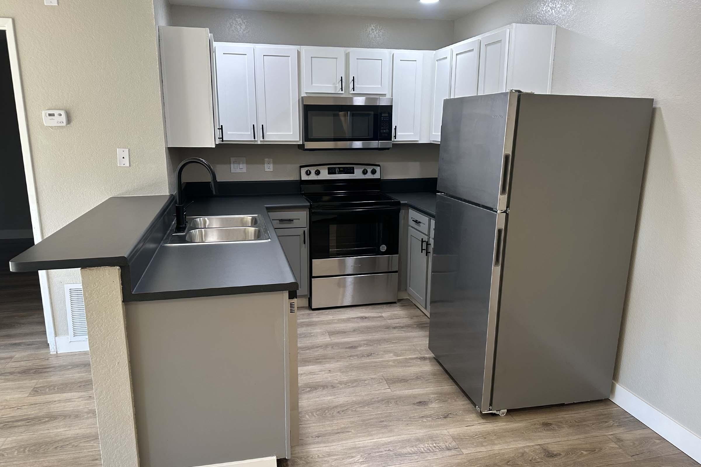 a kitchen with a stove and a refrigerator