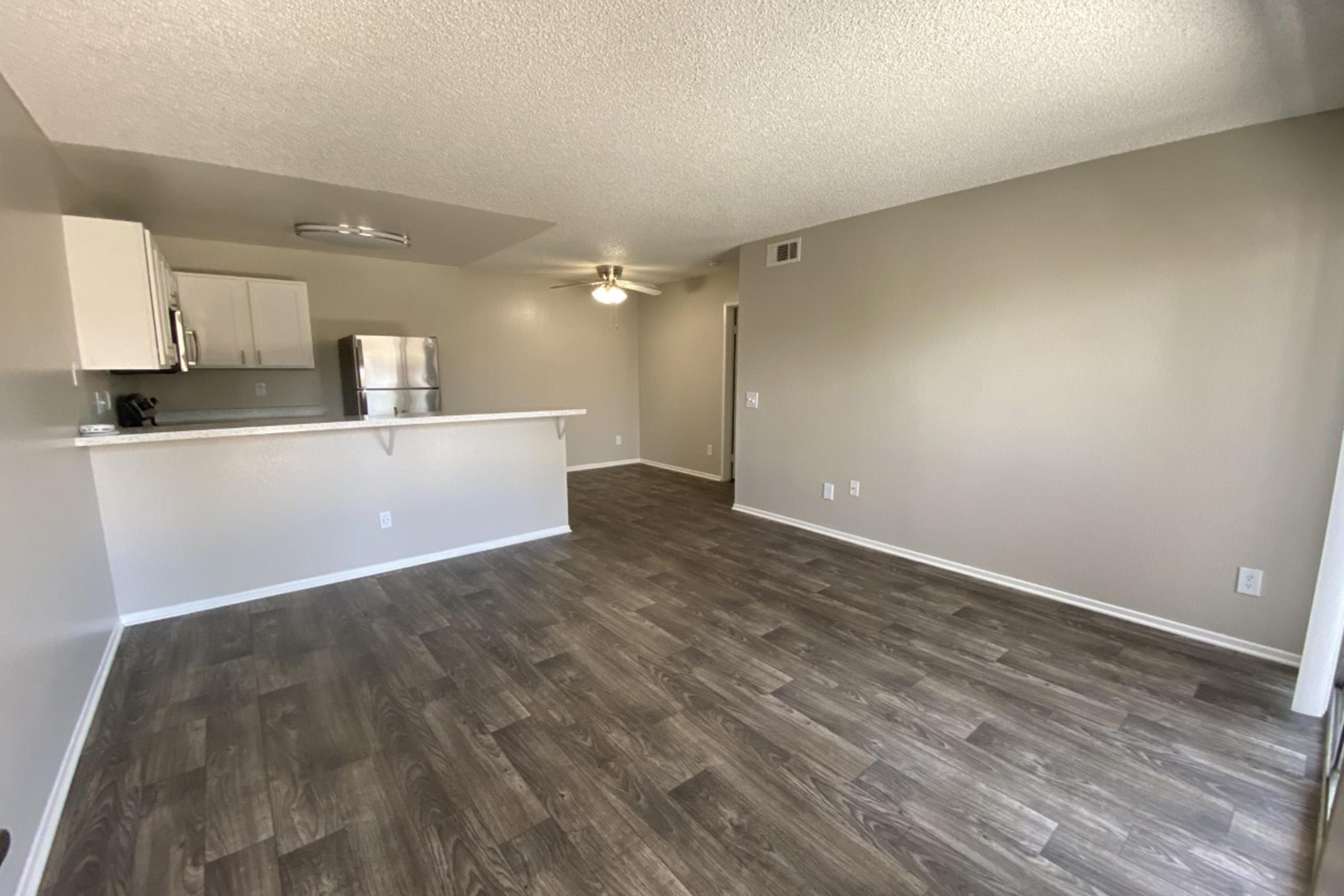 a large empty room with a wood floor