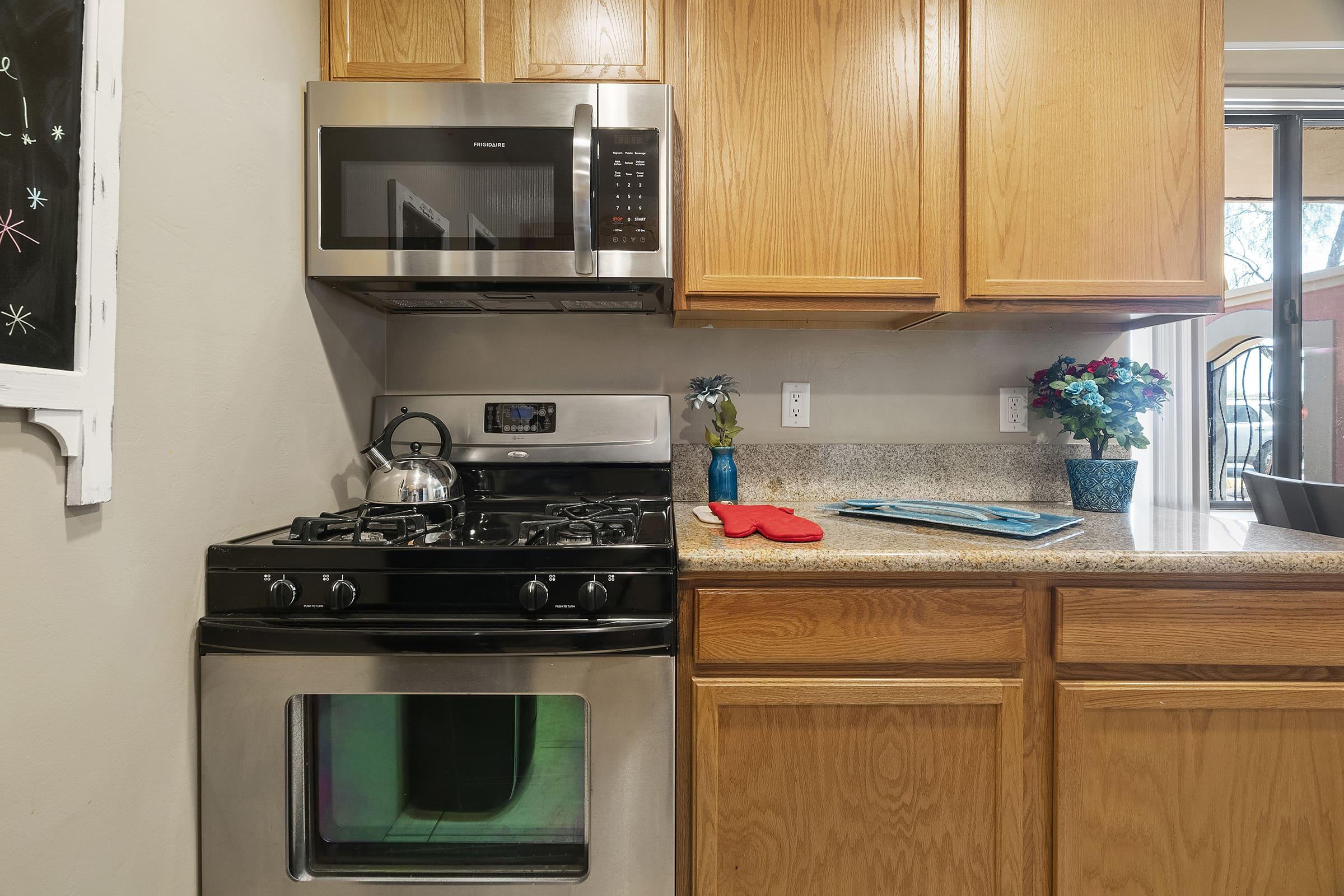 a kitchen with a stove top oven sitting inside of a microwave