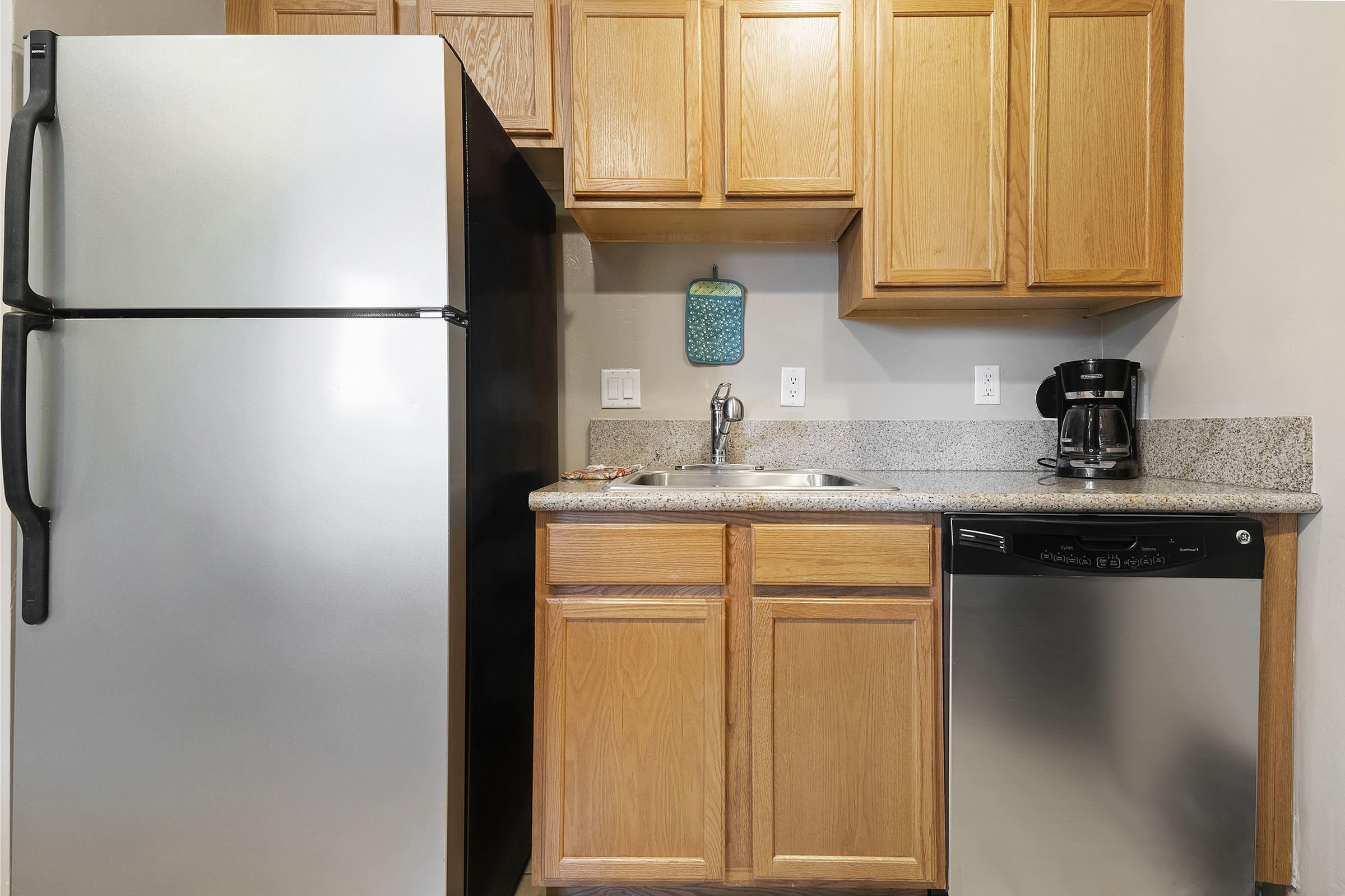 a kitchen with stainless steel appliances and wooden cabinets