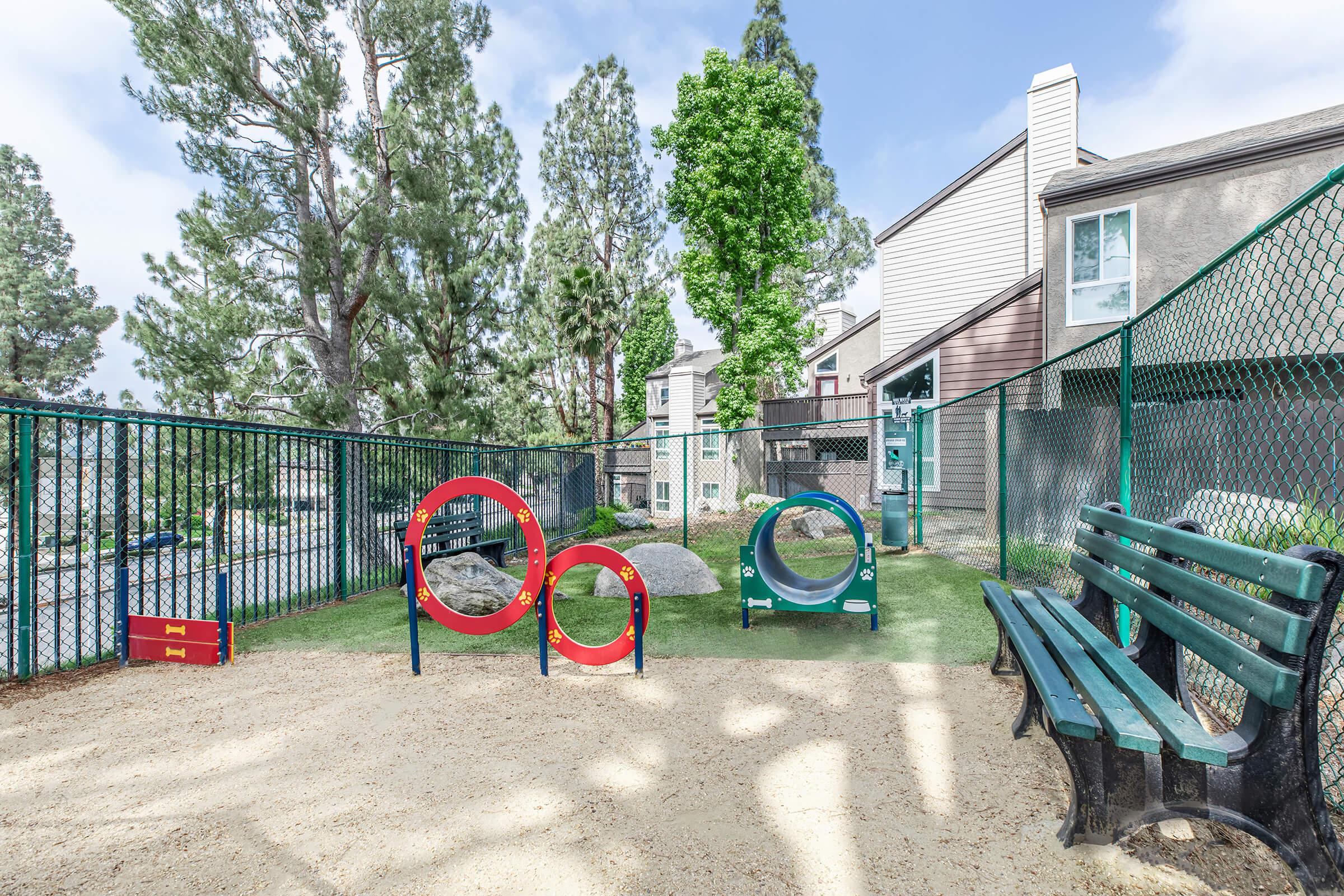 Riverside CA luxury apartments with In-Unit Washer and Dryer - Canyon Crest Views - Fenced Dog Park With Agility Hoops And Tunnel, Benches, And Shaded Play Area Near Apartment Homes