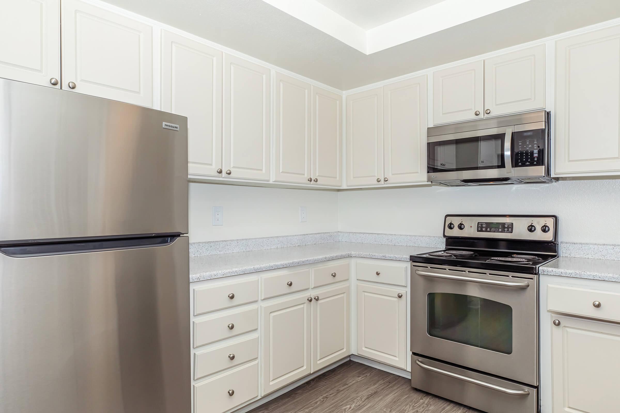 Dog-Friendly Luxury Apartments In Riverside, CA - Canyon Crest Views - Fully-equipped Kitchen With Hardwood Floors, Marble Countertops, And Lots Of Cabinet Space