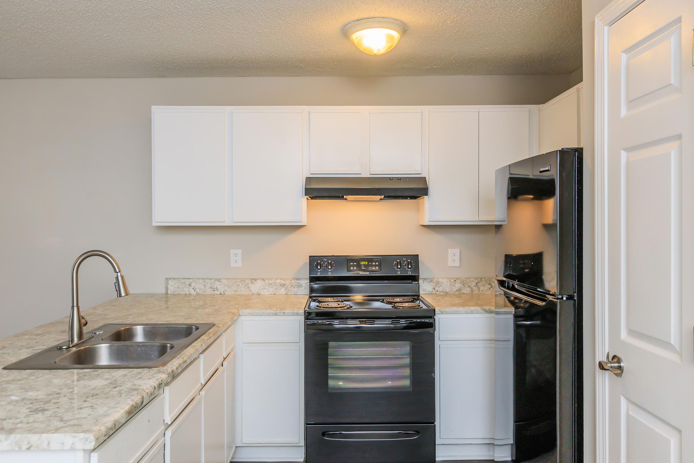 a kitchen with a stove and a sink