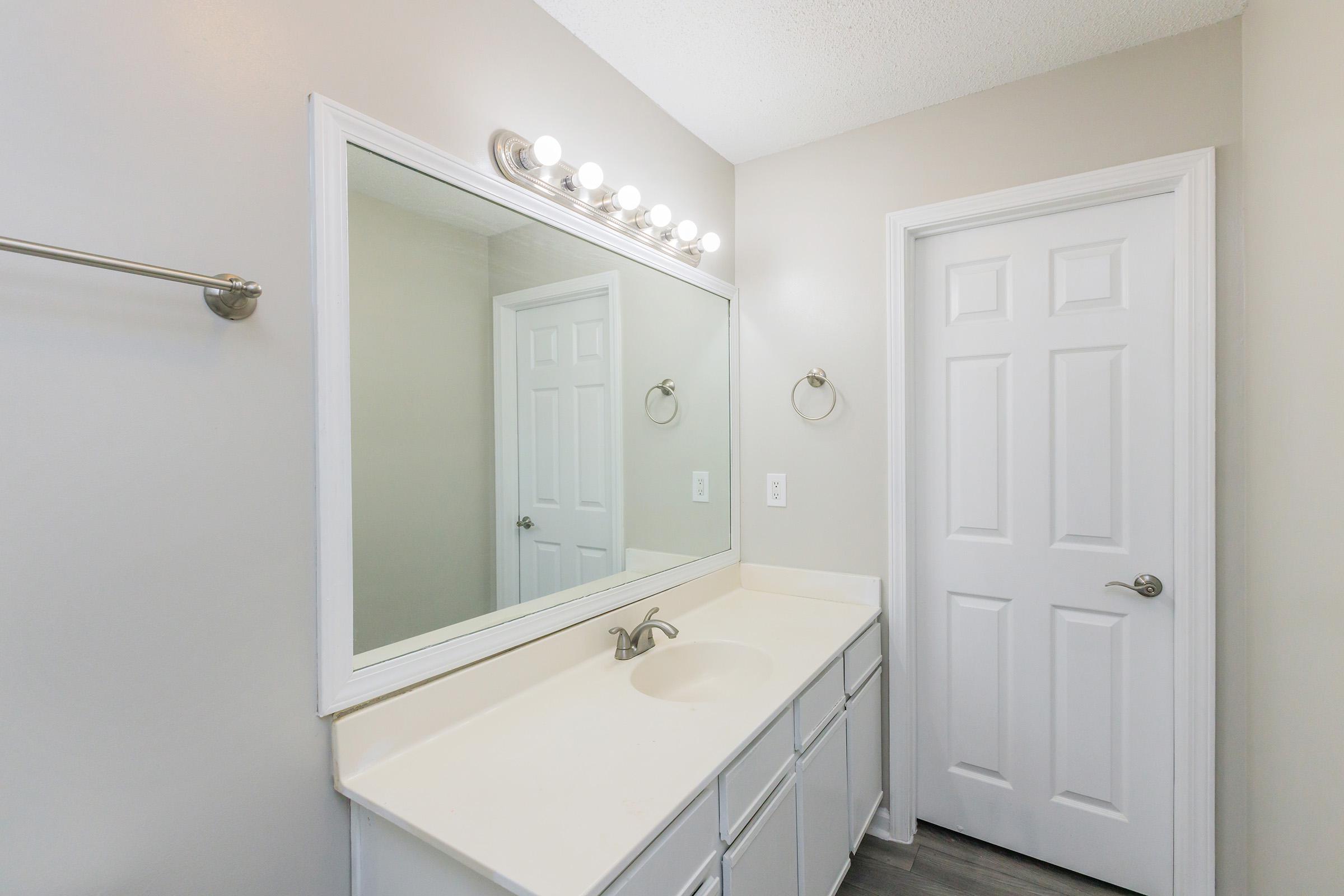 a room with a sink and a mirror