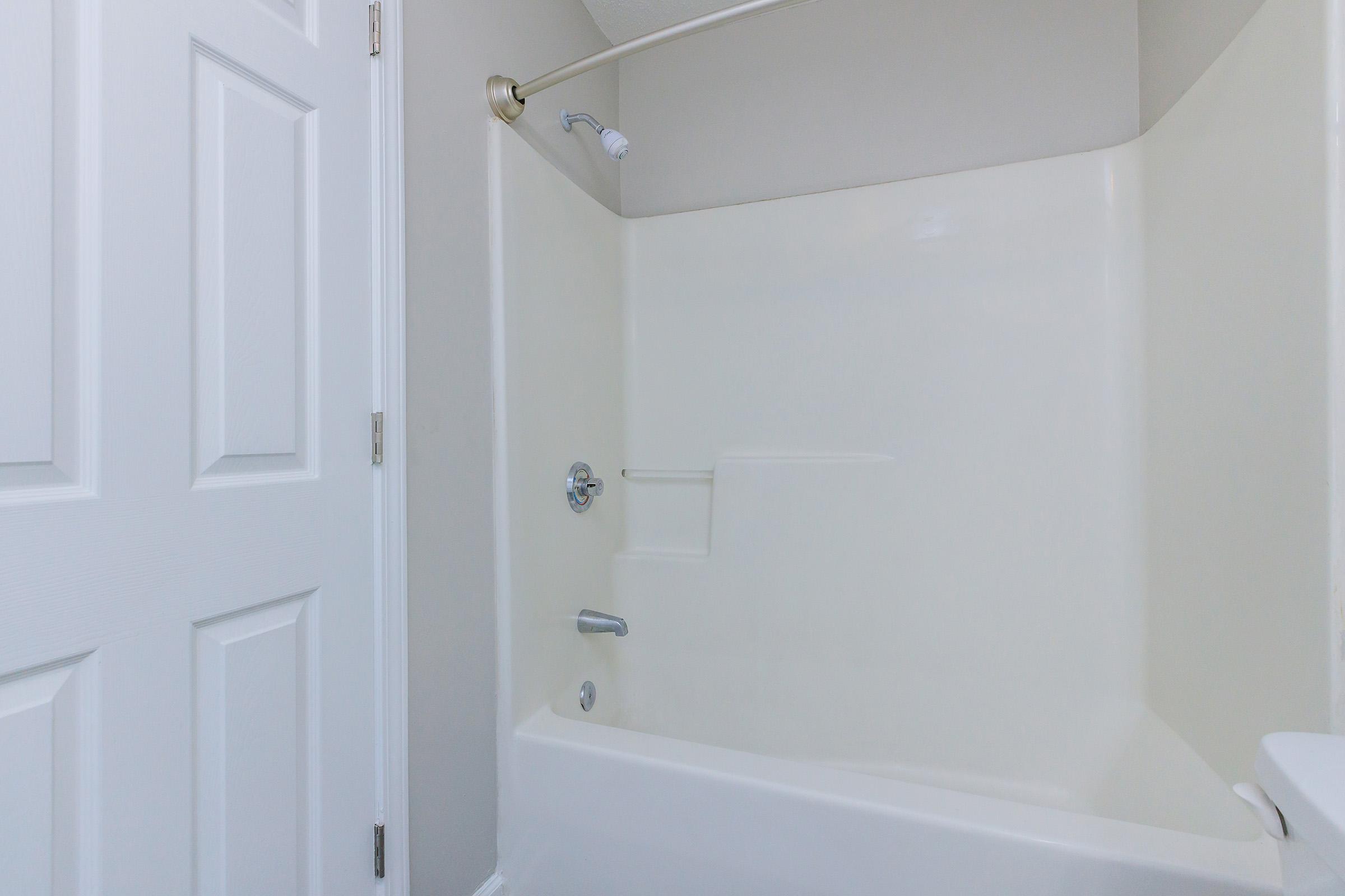 a large tub next to a shower