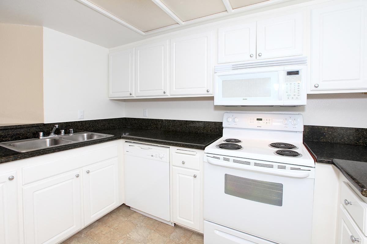 a white stove top oven sitting inside of a kitchen