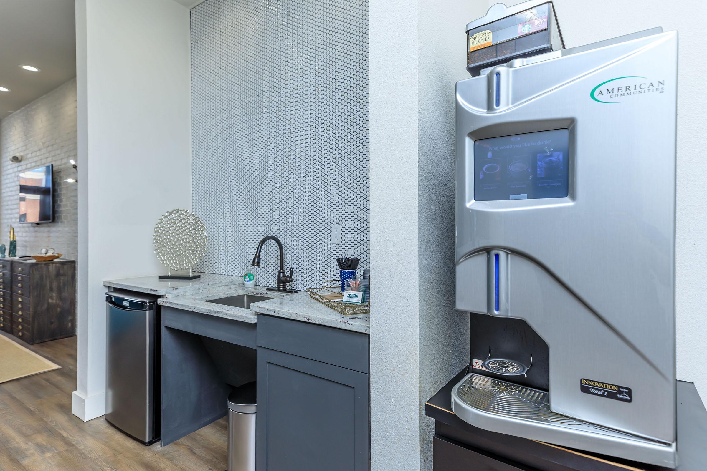 a kitchen with a sink and a mirror