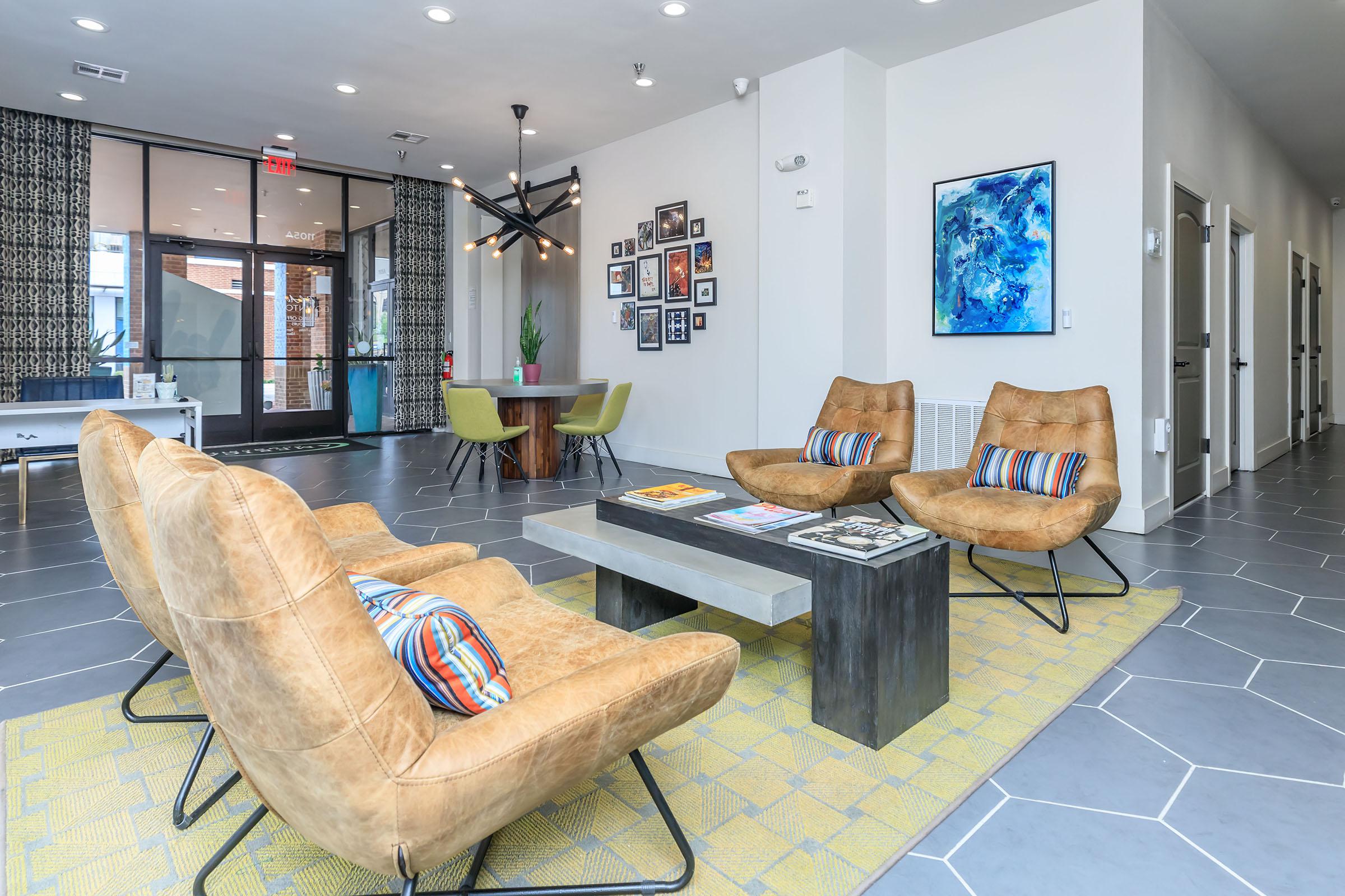 a living room filled with furniture and a large window