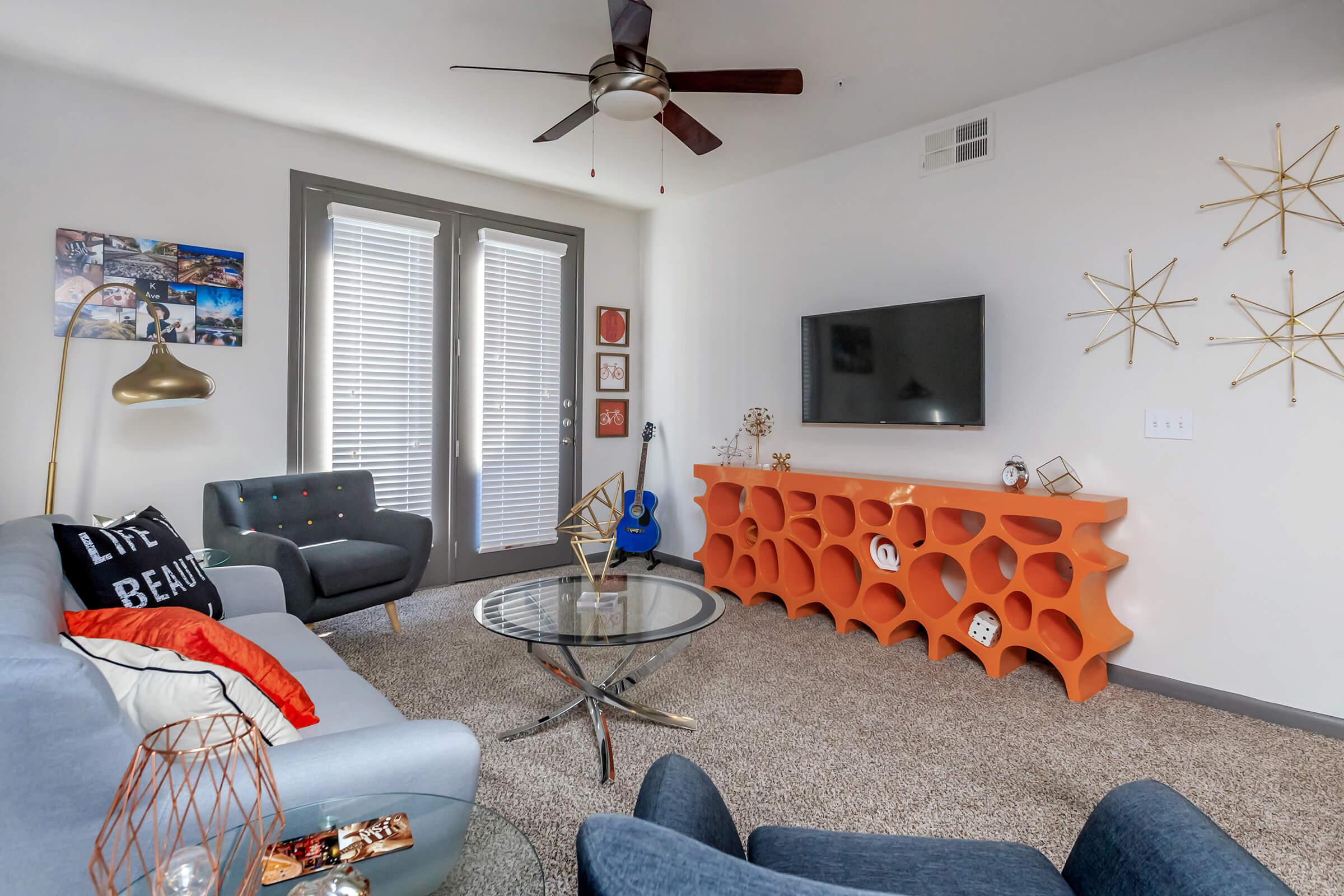 a living room filled with furniture and a tv