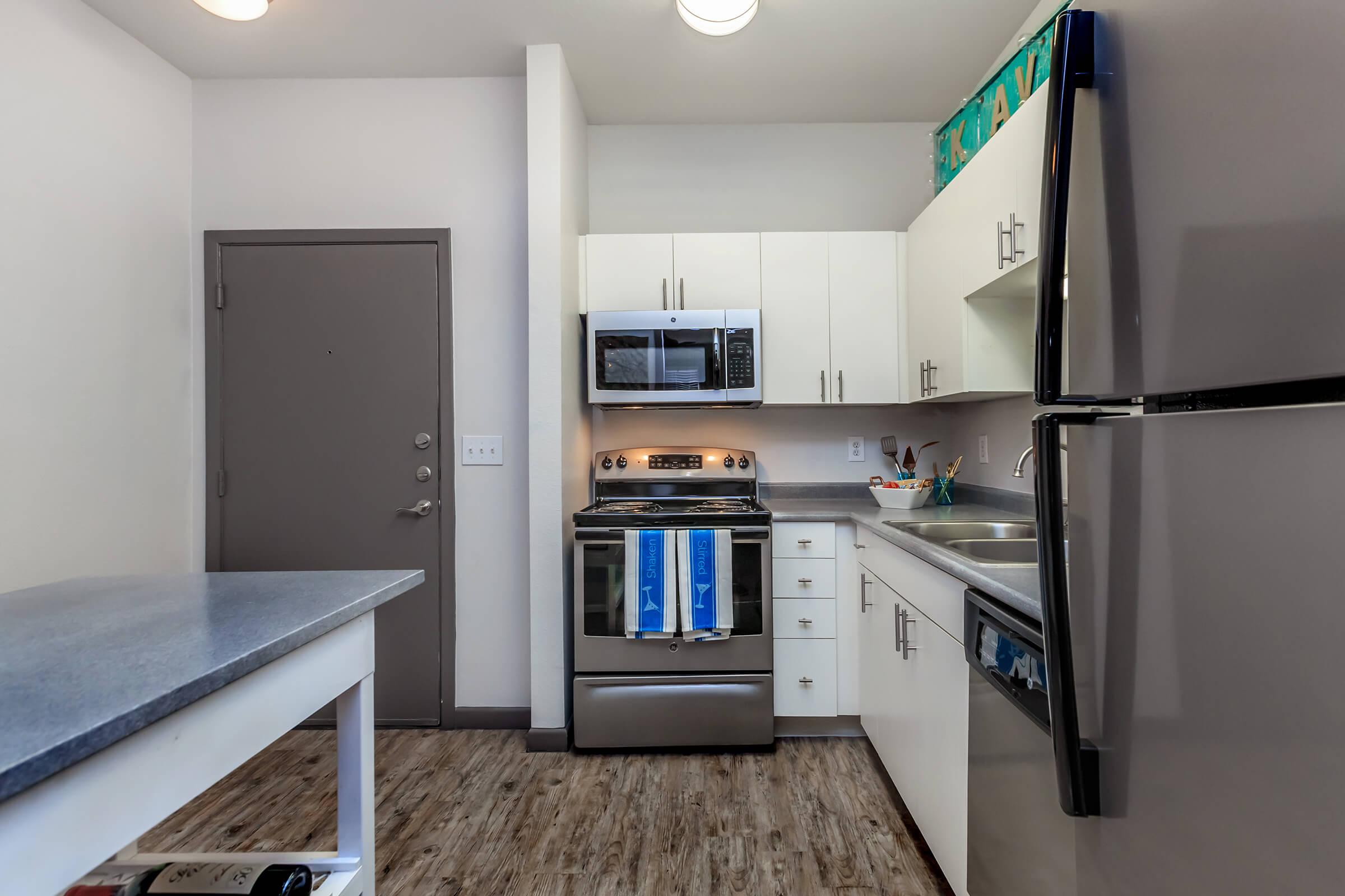 a kitchen with a stove top oven sitting inside of a room