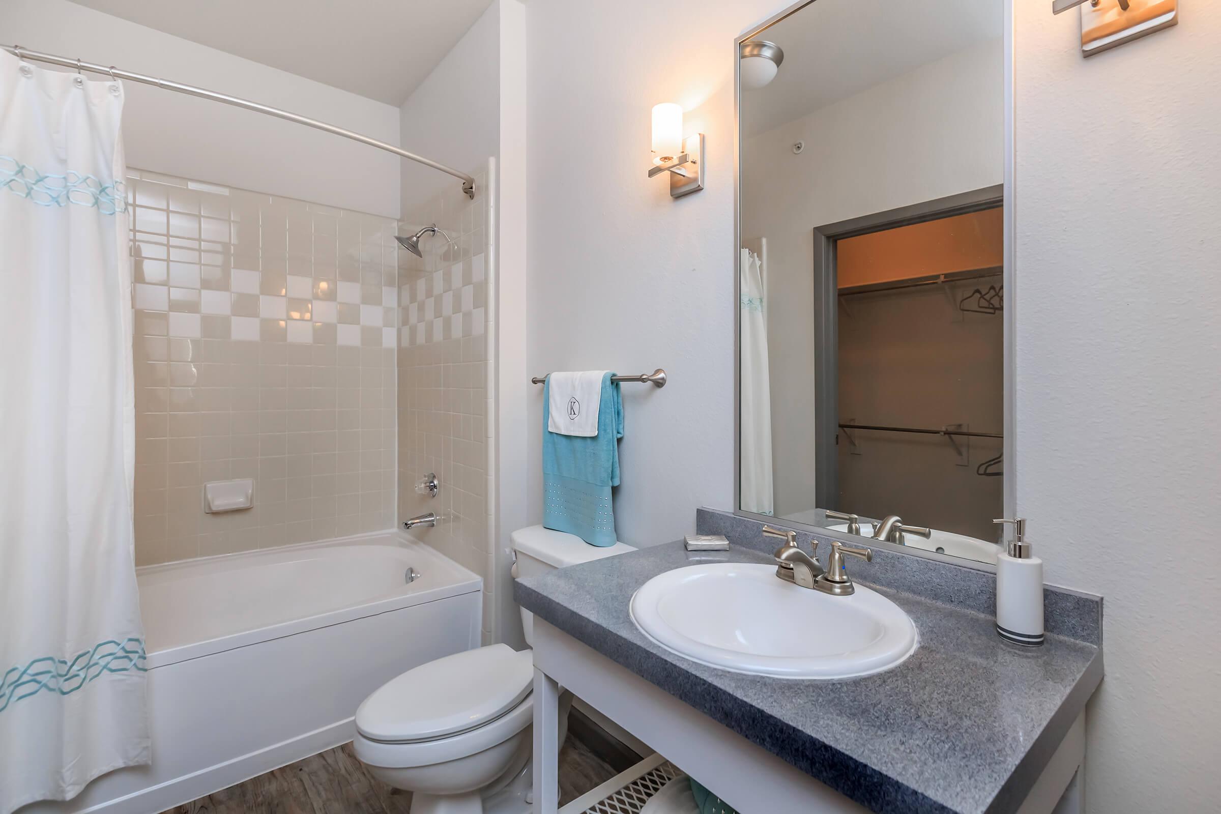 a white sink and a mirror
