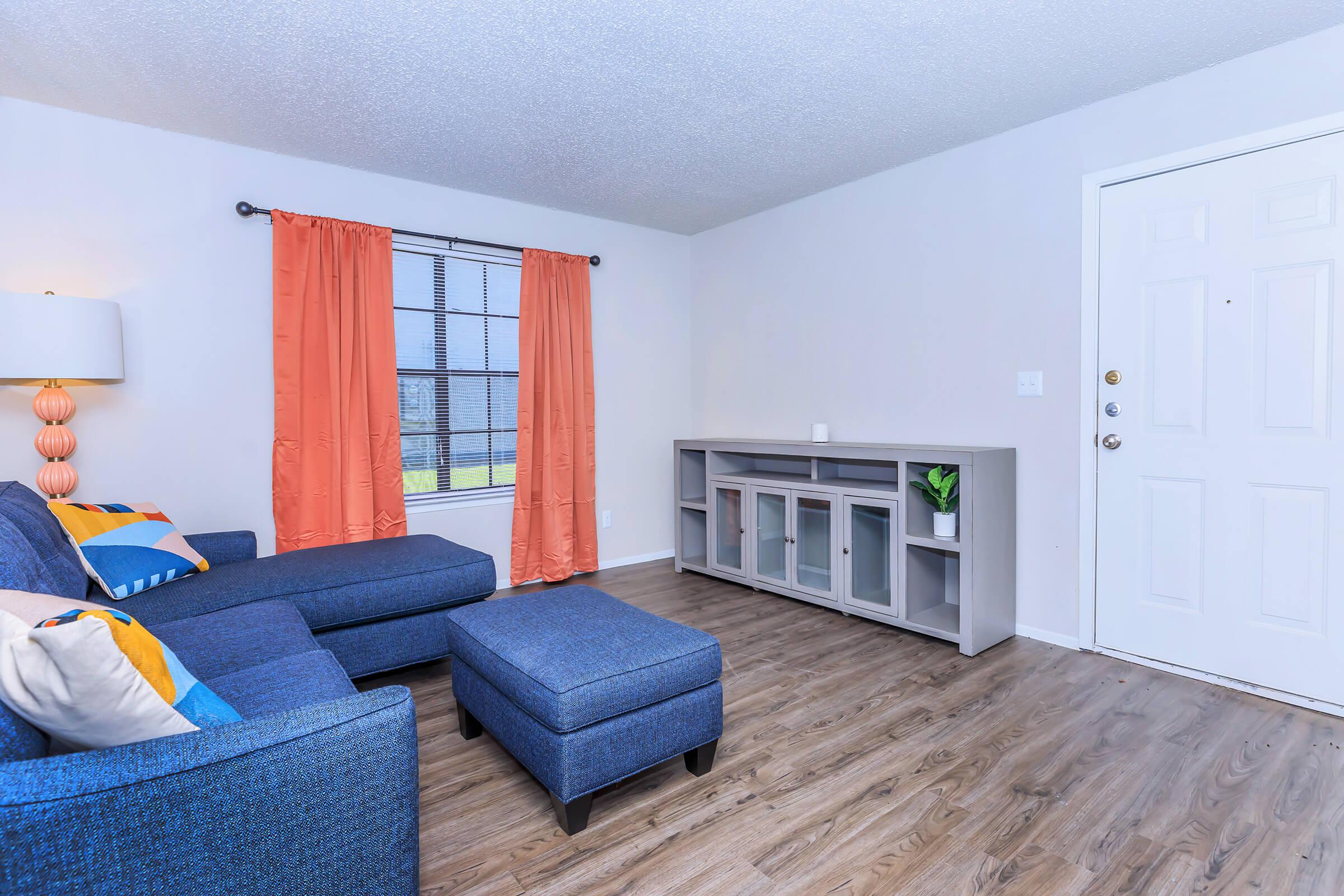 a living room filled with furniture and a blue sky