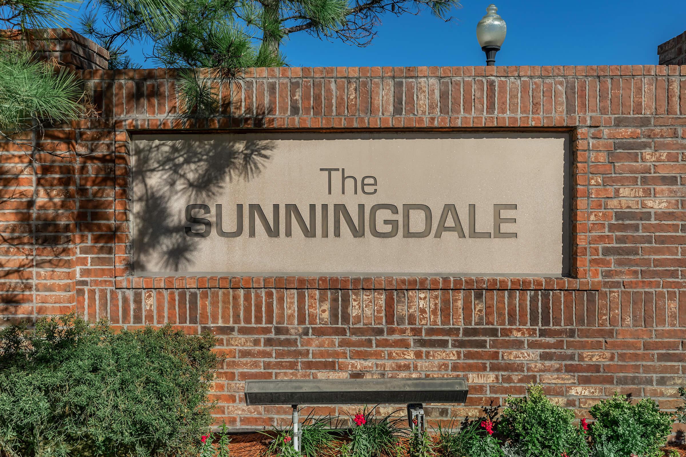 a sign in front of a brick building