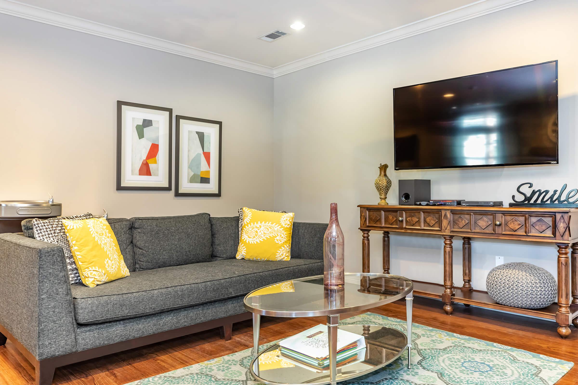 a living room filled with furniture and a flat screen tv