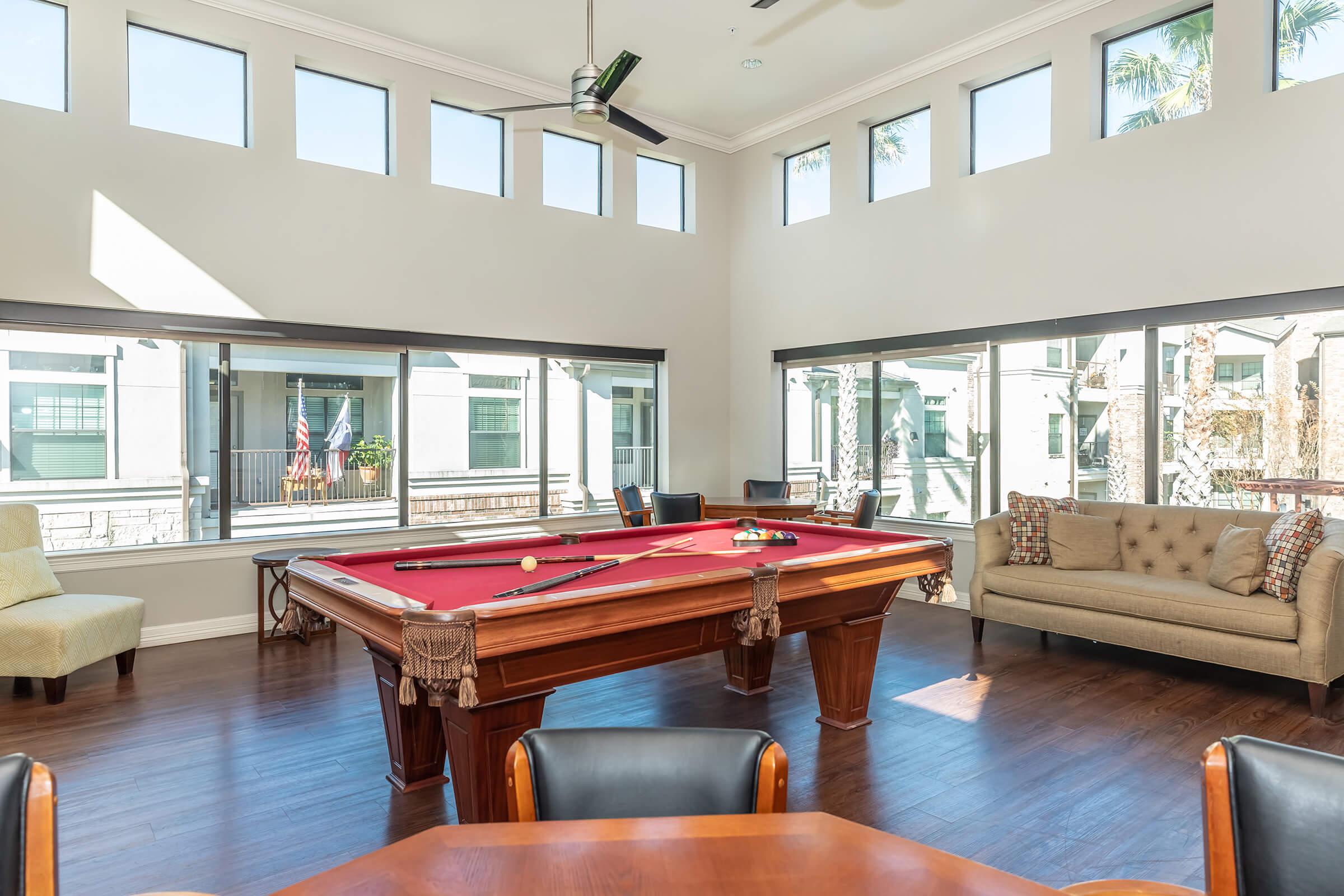 a living room filled with furniture and a large window