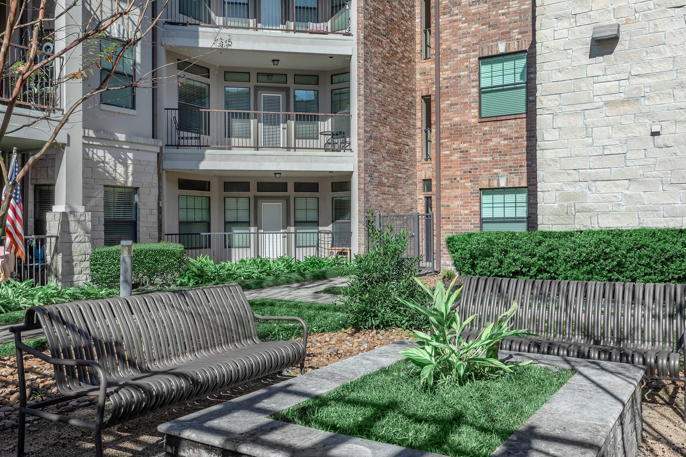 a bench in front of a brick building