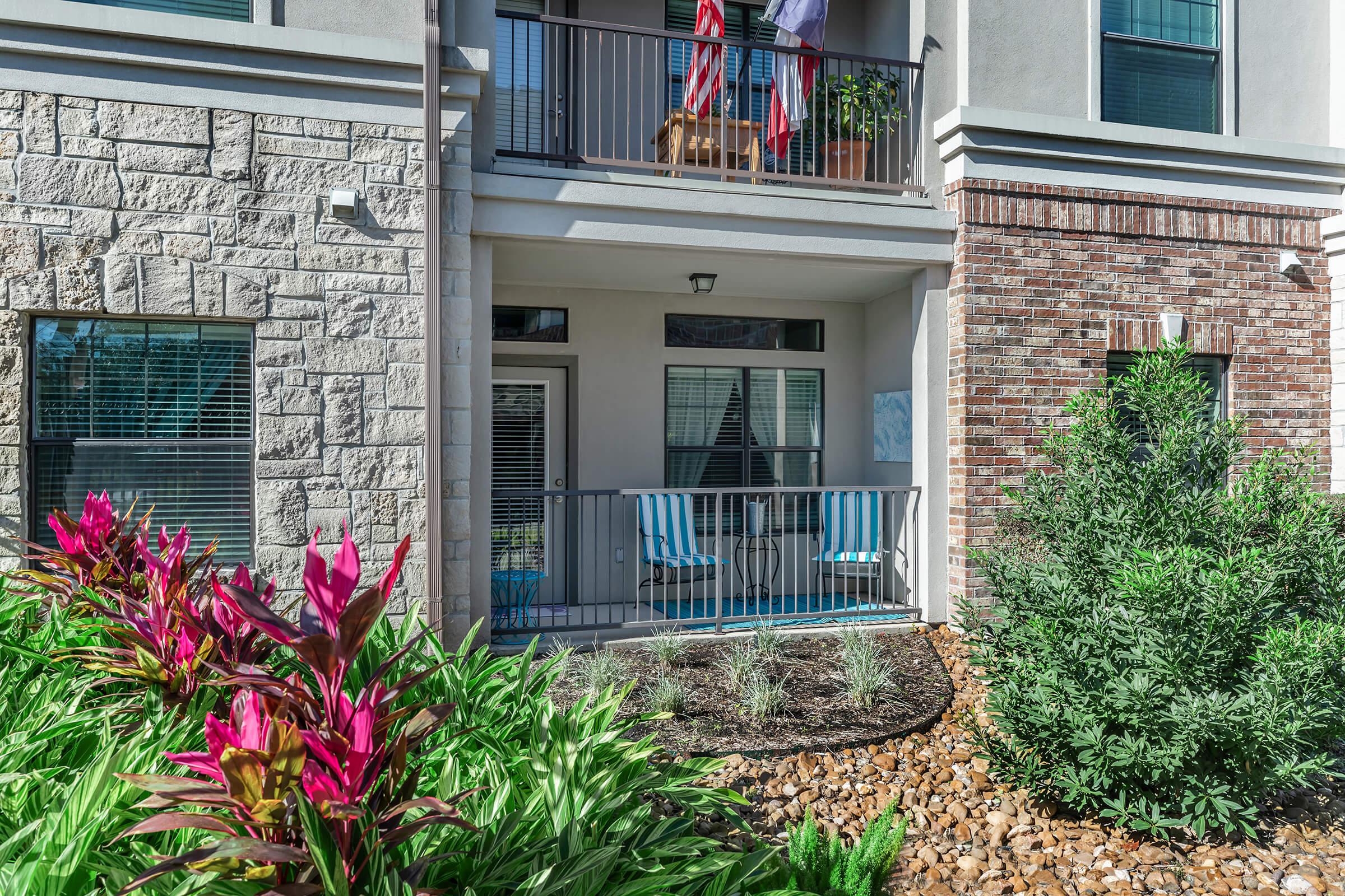 a close up of a flower garden in front of a building