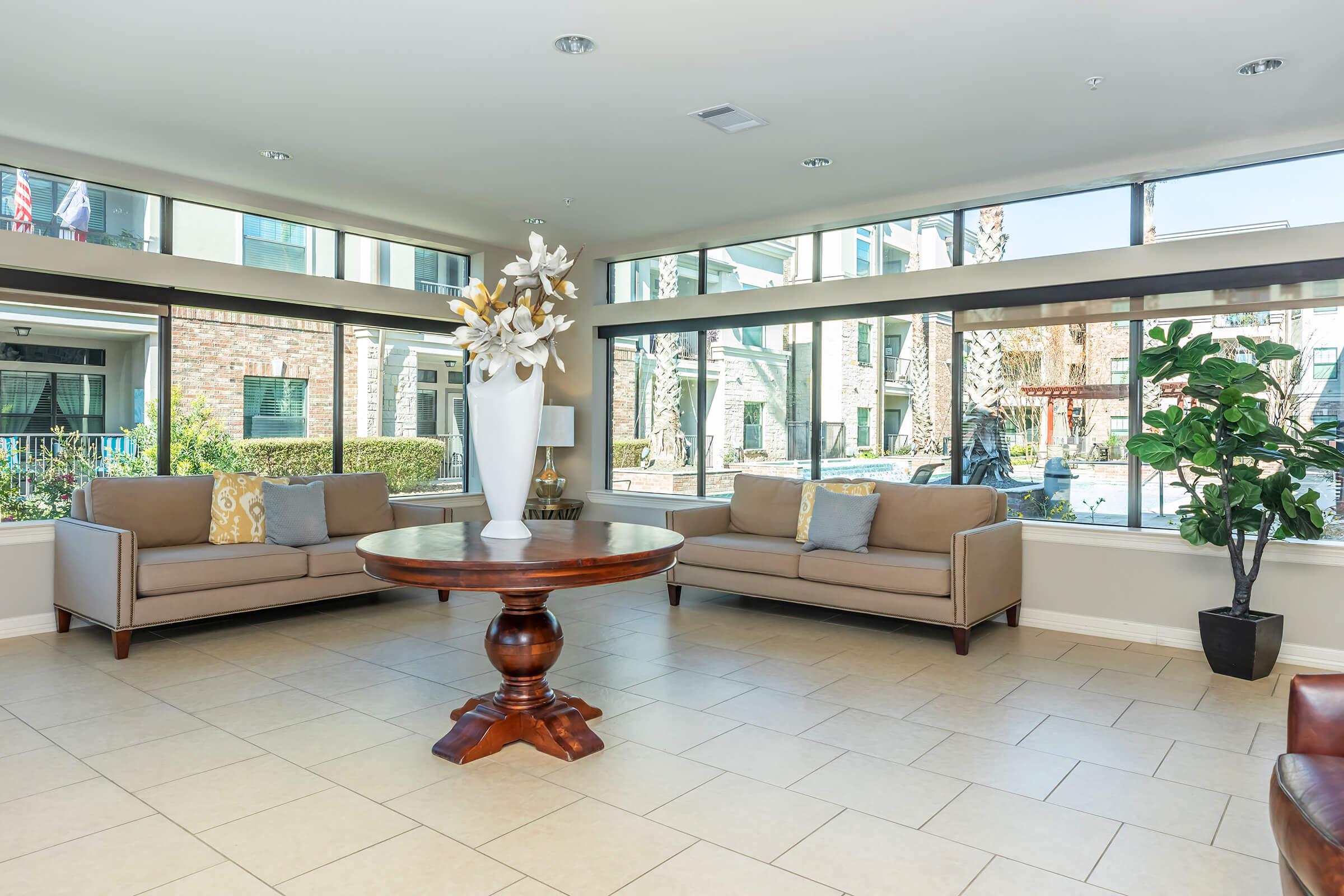 a living room filled with furniture and a large window