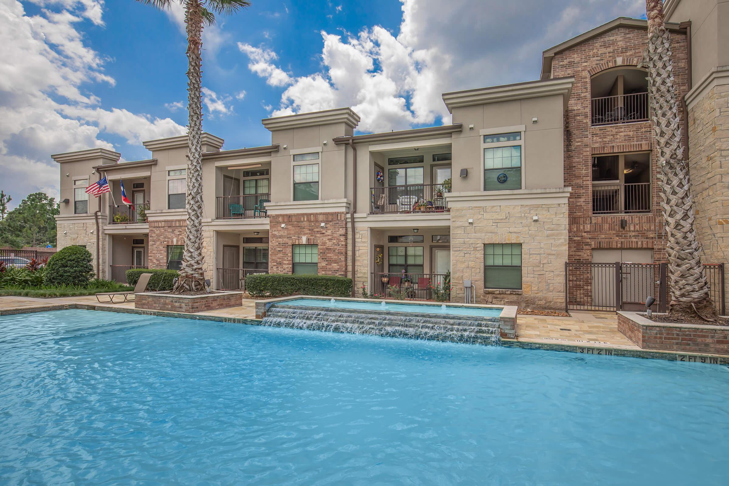 a large pool of water in front of a house