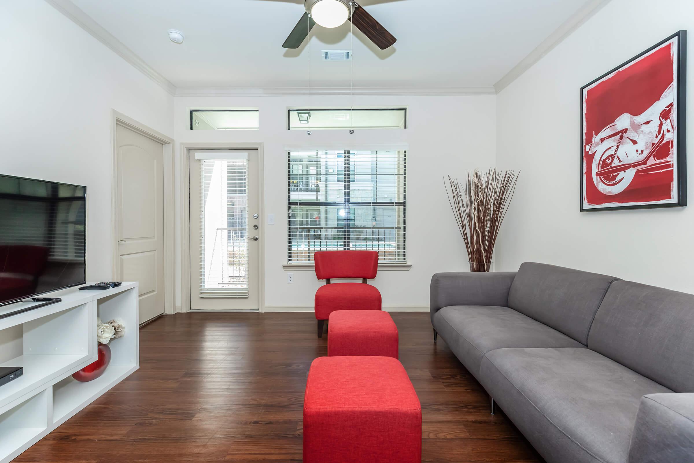 a living room filled with furniture and a flat screen tv