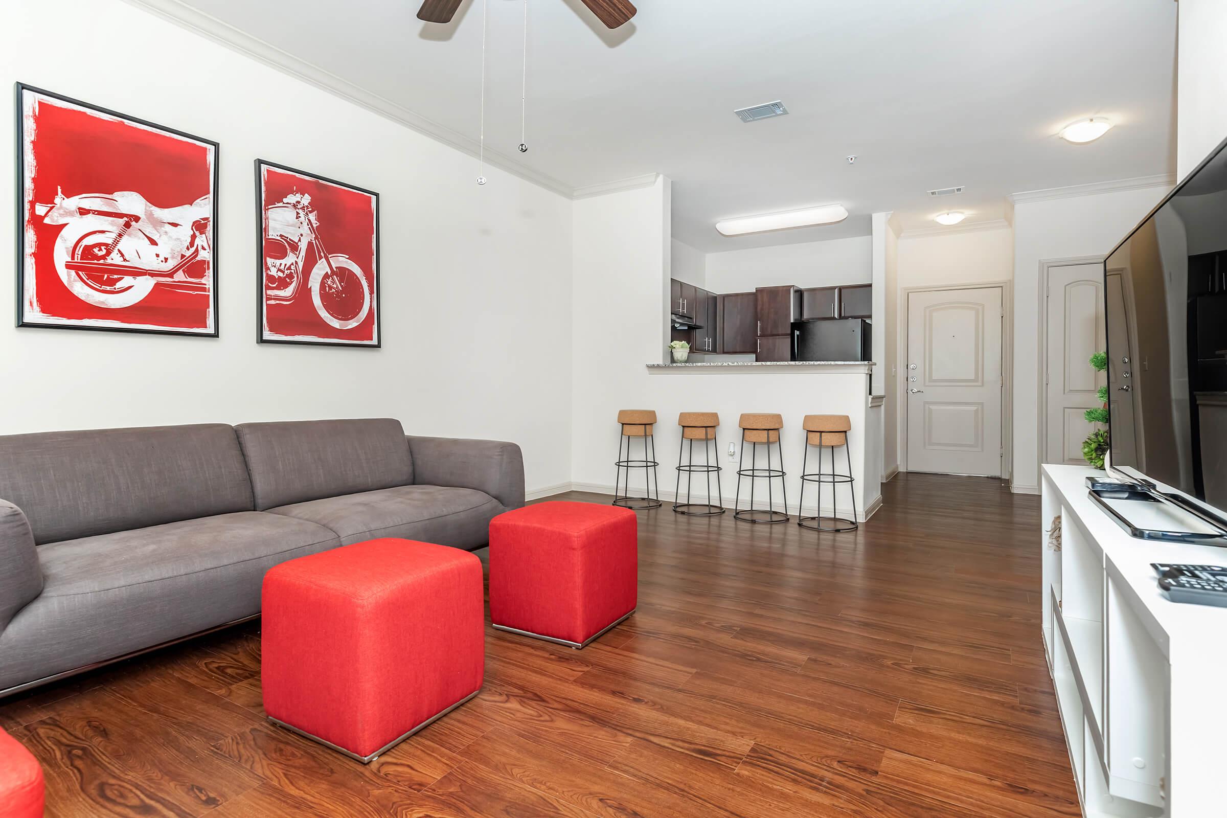 a living room filled with furniture and a wood floor