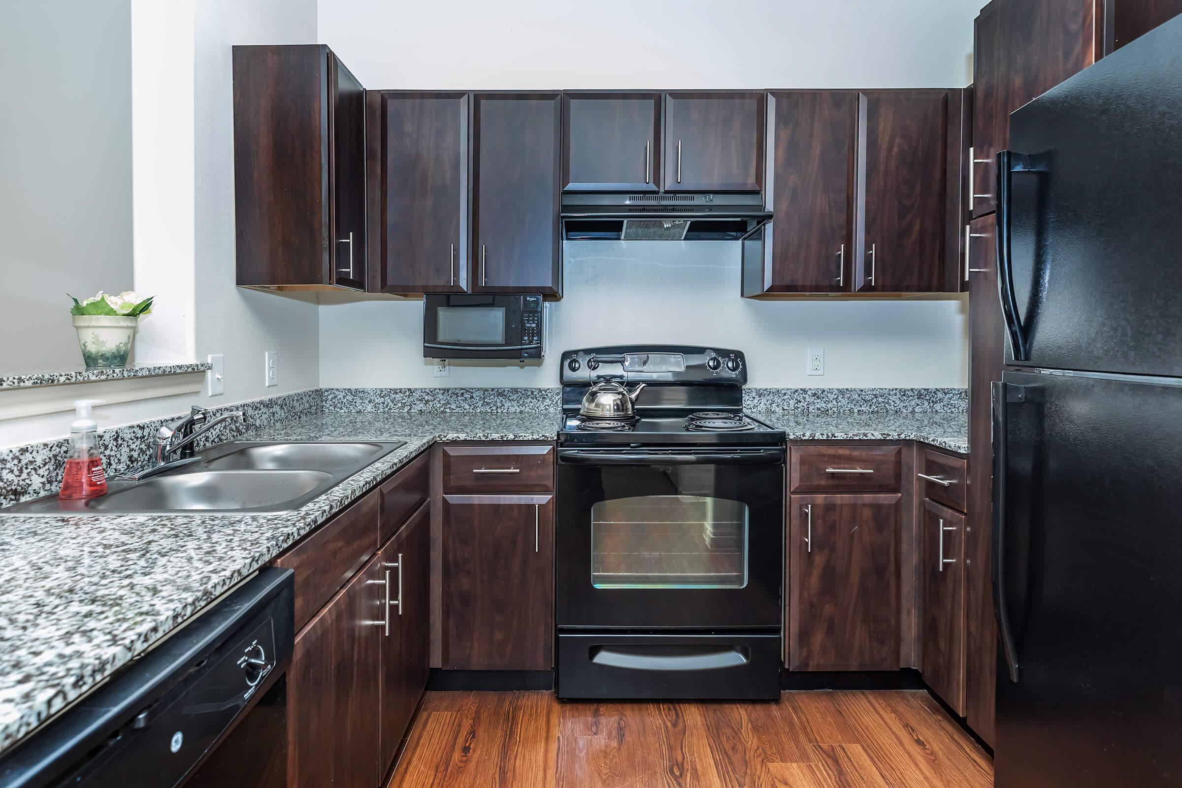 a kitchen with stainless steel appliances and wooden cabinets