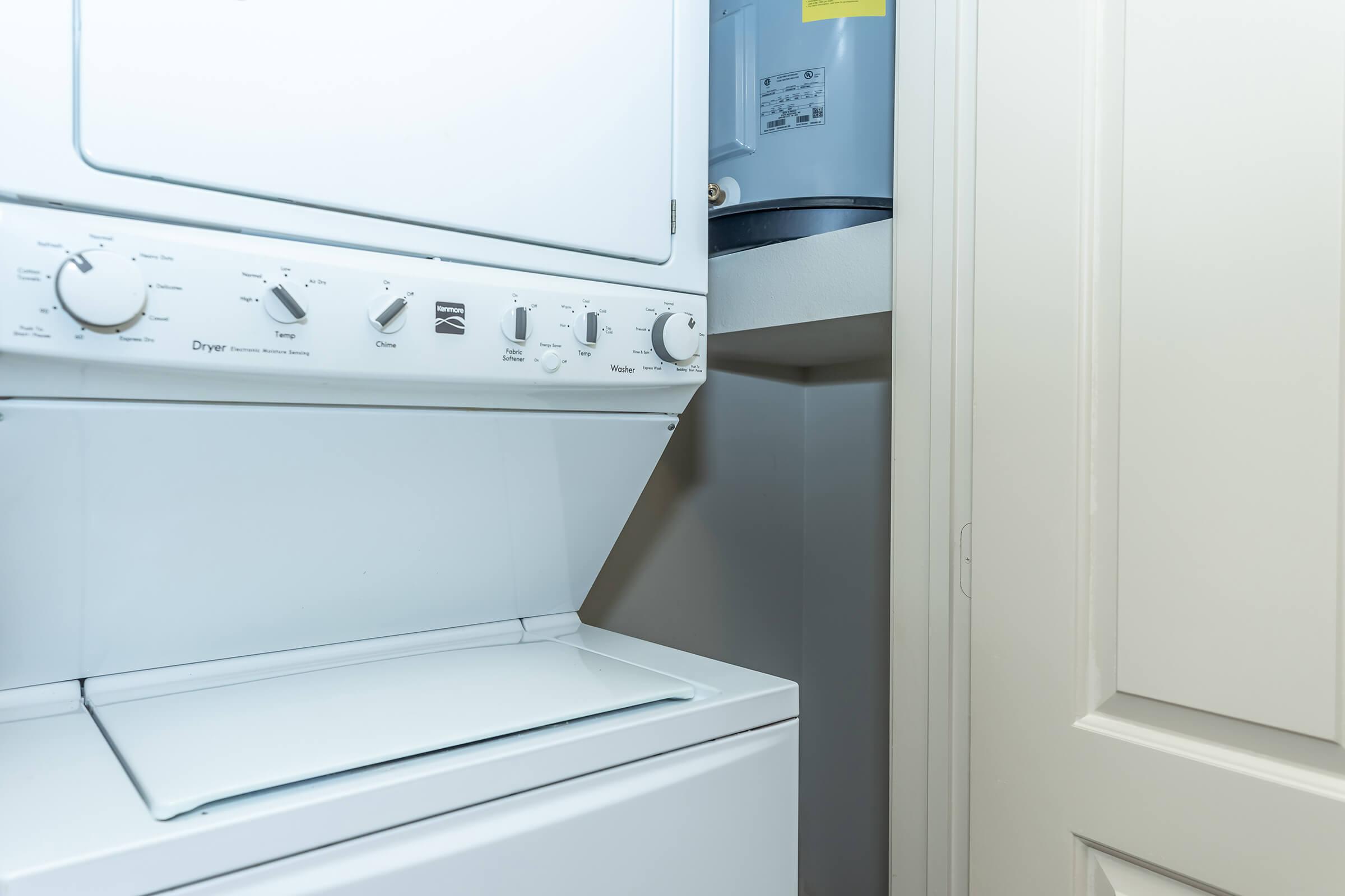 a microwave oven sitting on top of a refrigerator