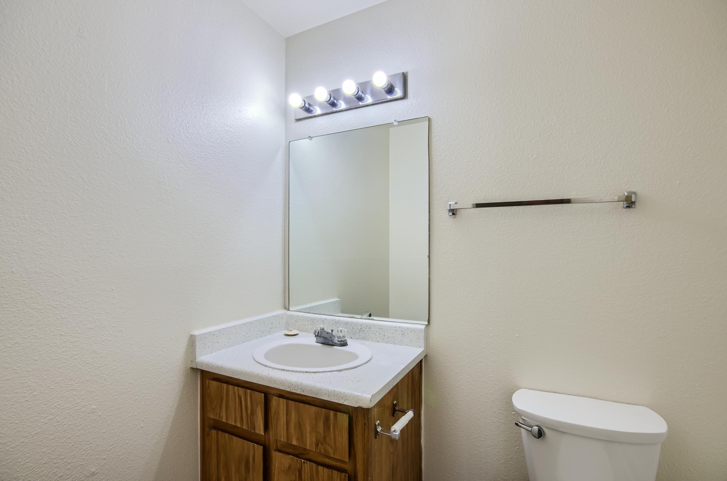 Mesa, AZ apartment bathroom with a sink, mirror and toilet